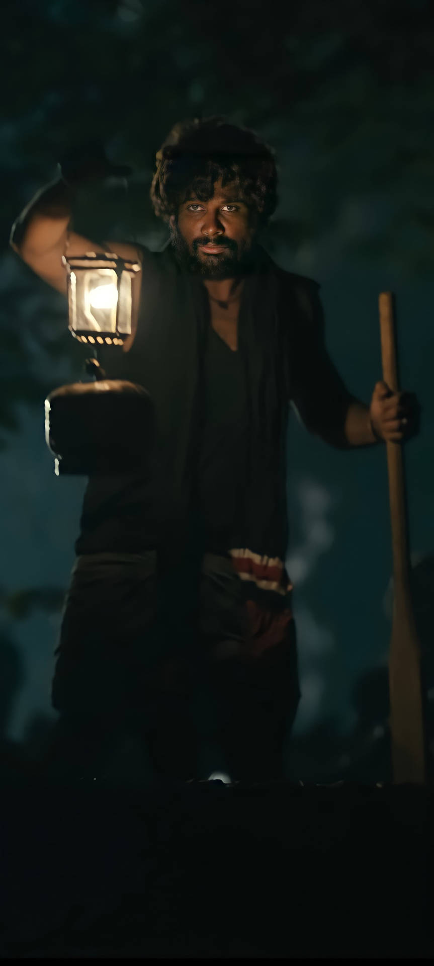 Intense Look of Allu Arjun as Pushpa Raj Under a Lamp Light Wallpaper