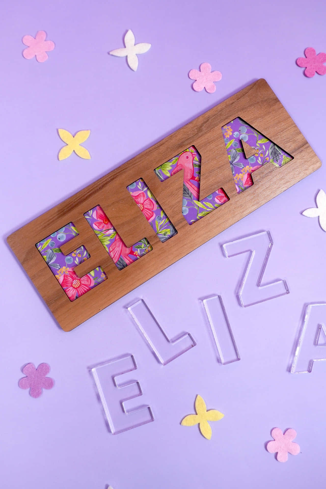 A Wooden Name Plaque With Flowers And Butterflies