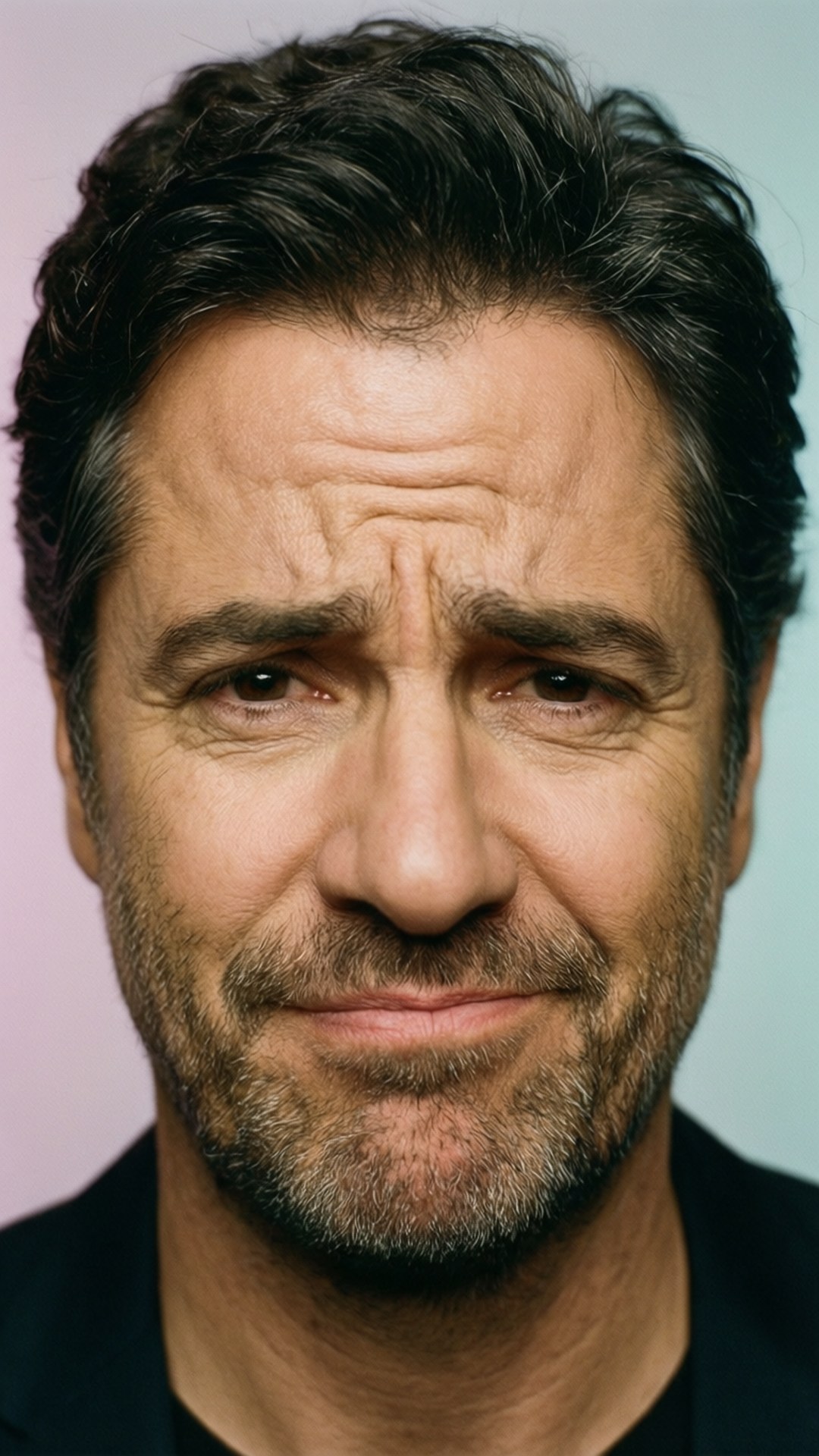 Ray Romano with a thoughtful and puzzled facial expression.