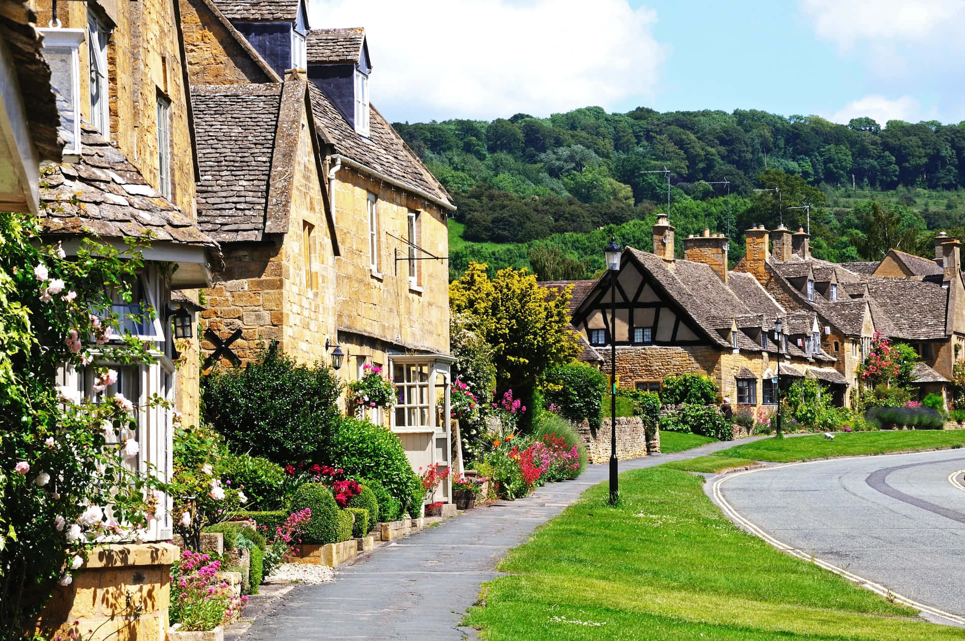 Quaint Cotswold Village Street U K Wallpaper