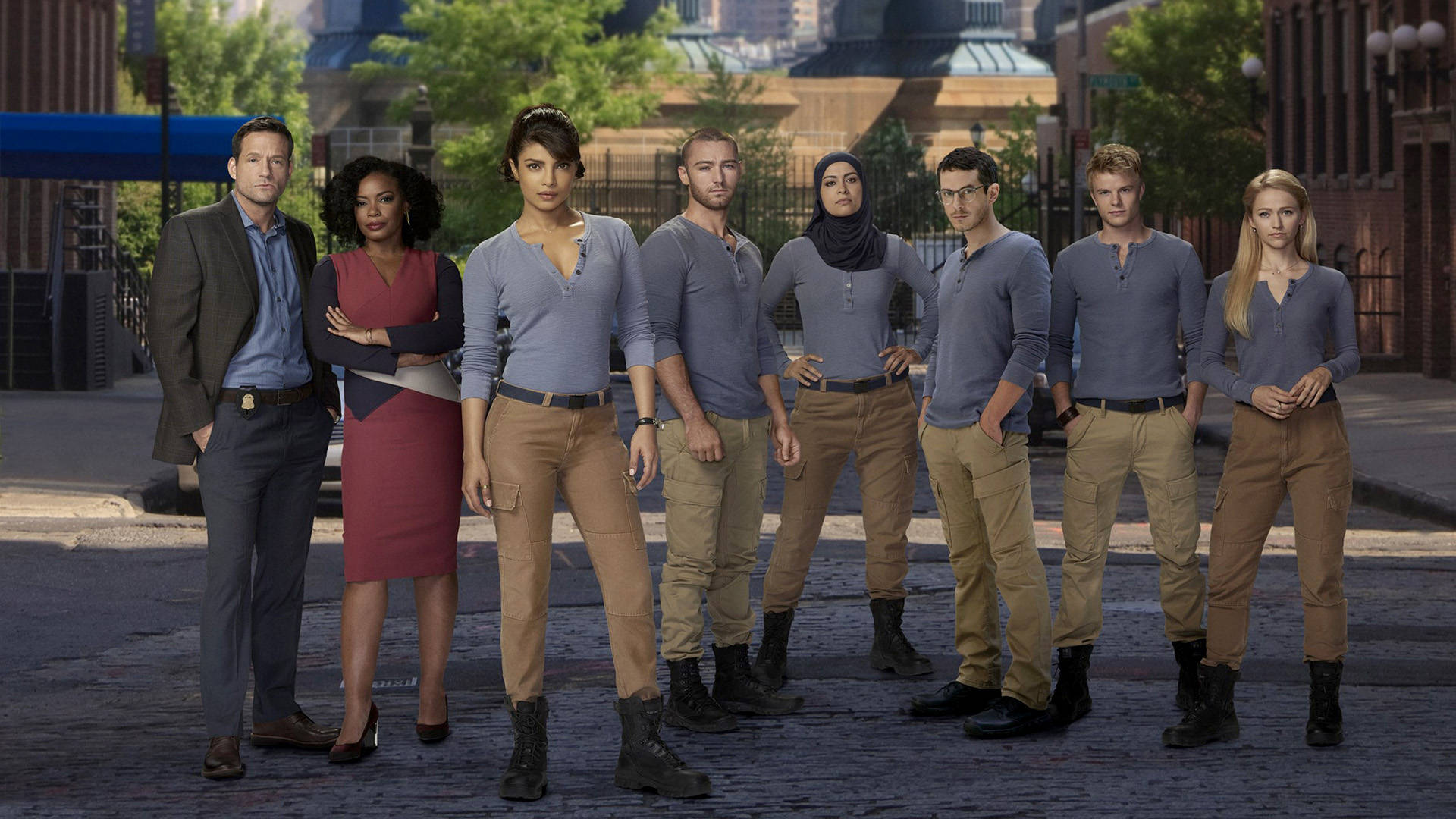 Quantico TV Series Characters Posing in the Foreground of FBI Academy Wallpaper
