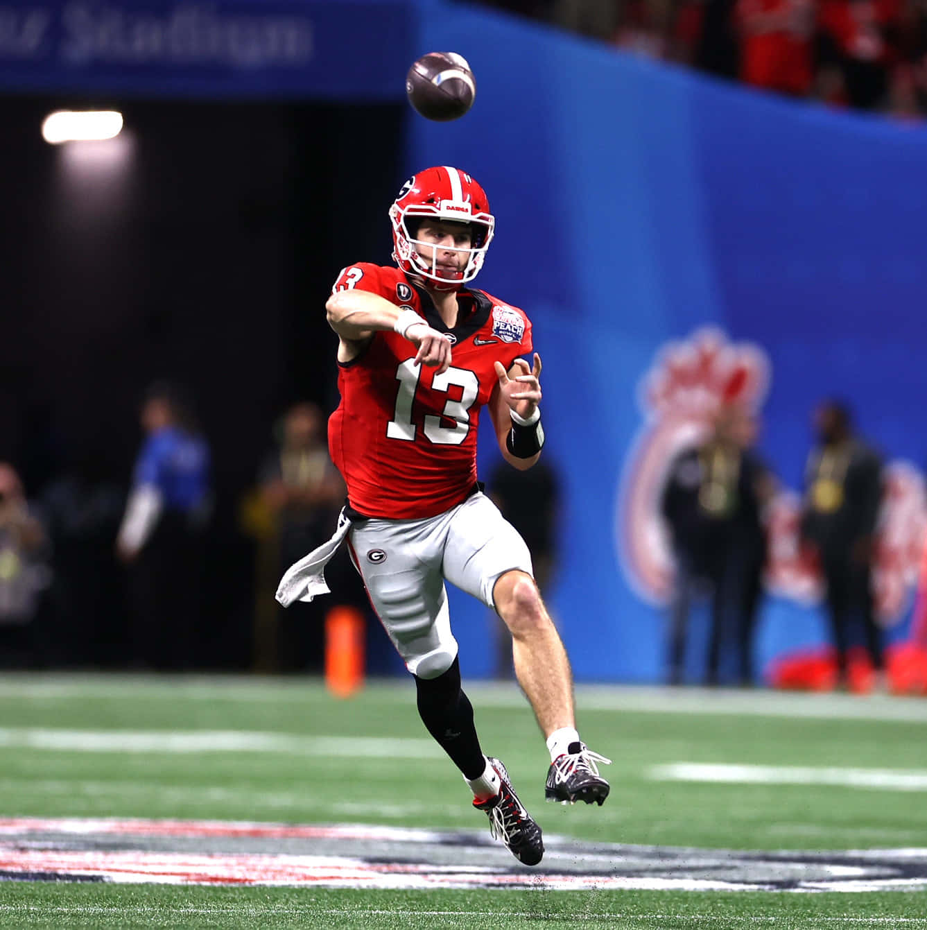 Quarterback Throwing Football During Game Wallpaper