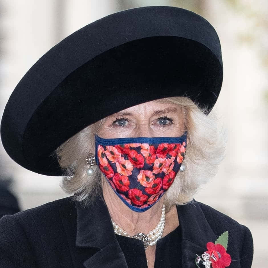Queen Camilla Donning a Poppy Mask Wallpaper