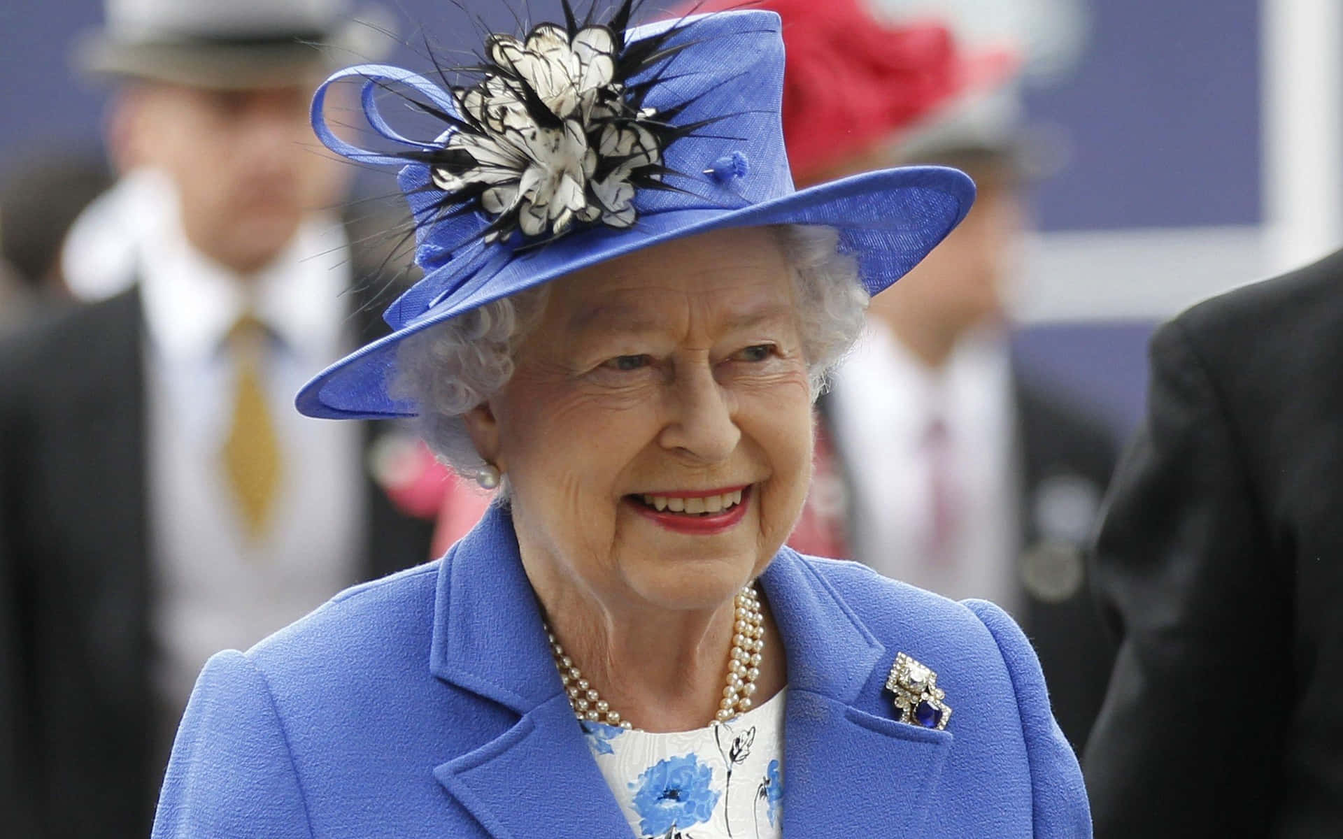 A portrait of Queen Elizabeth II with a vibrant smile on her face