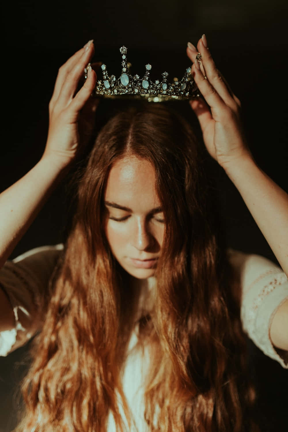 A Woman With Long Hair Wearing A Crown