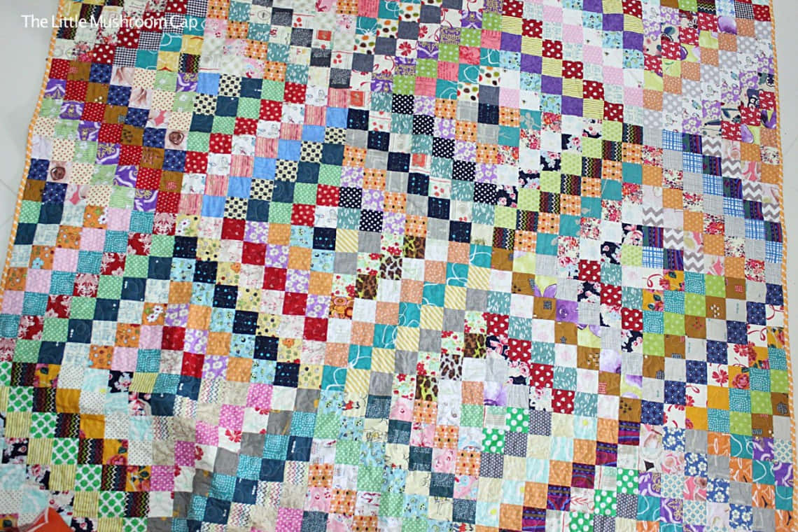 A Quilt With A Colorful Pattern On It Wallpaper