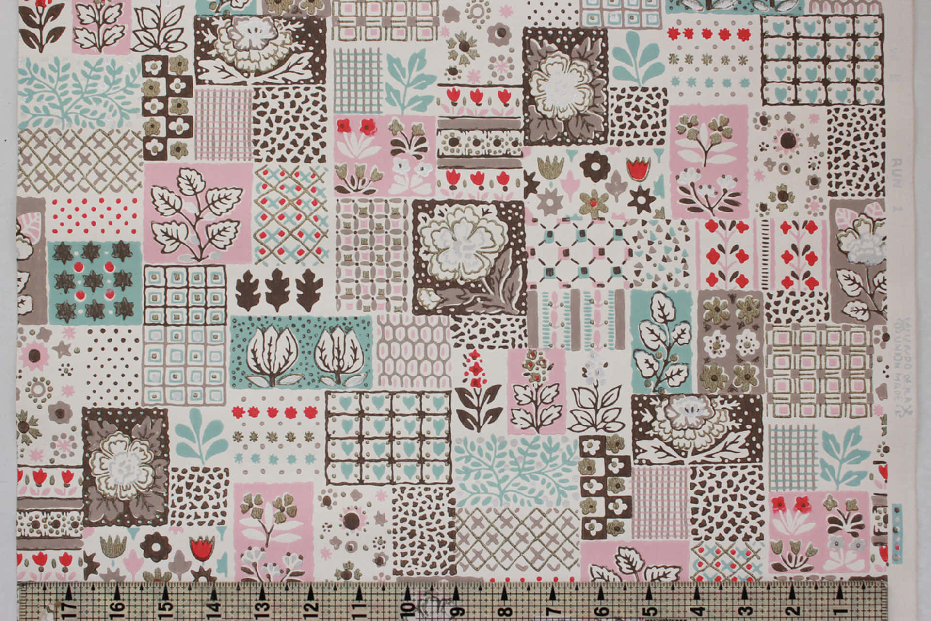 A Pink And Brown Quilt With A Ruler Wallpaper