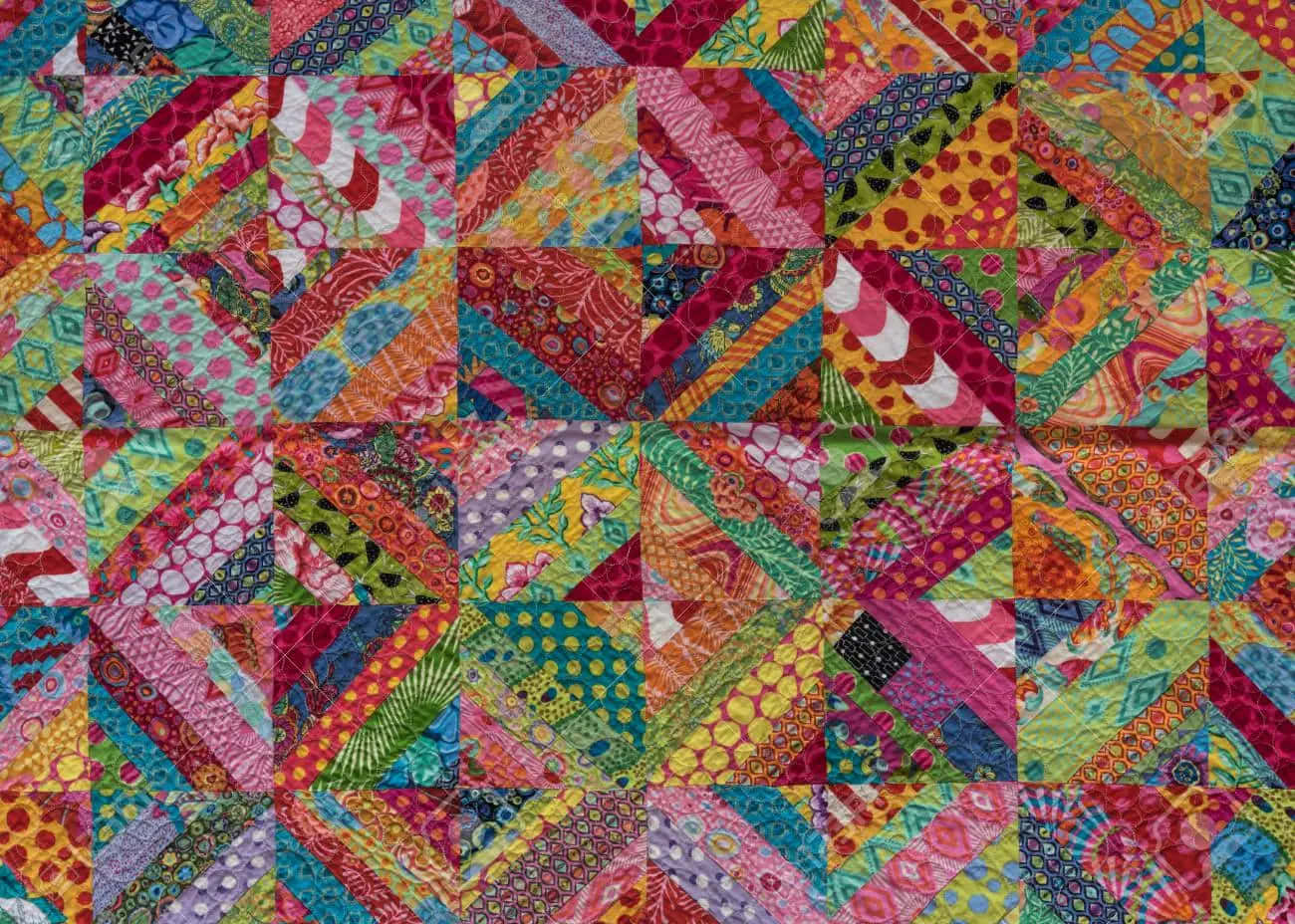 A Colorful Quilt With Many Colorful Squares Wallpaper