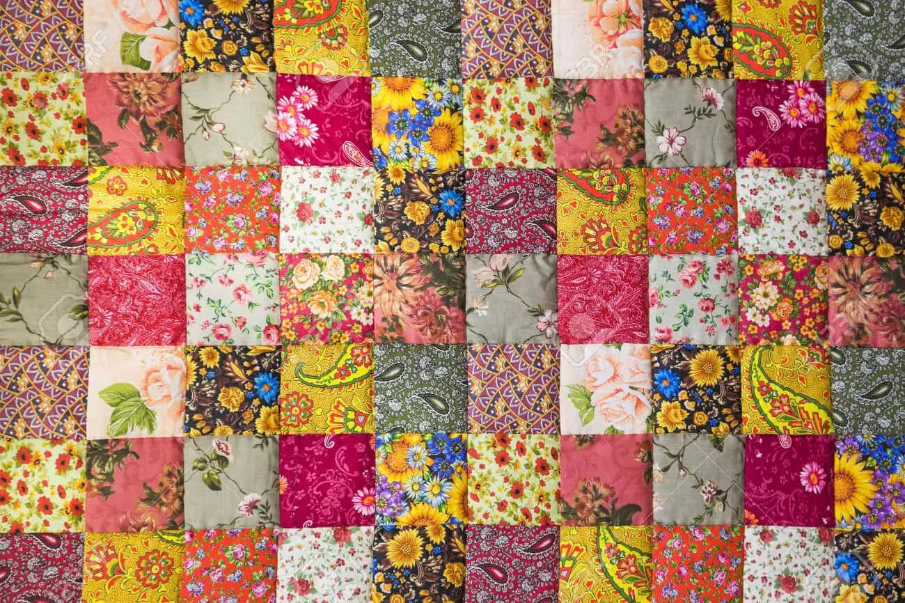 A Colorful Quilt With A Floral Pattern Wallpaper