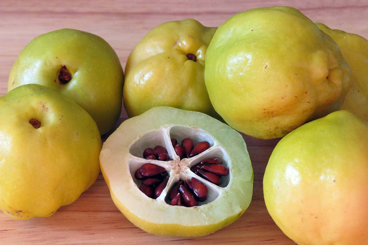 A yellow quince fruit with a cheerful expression