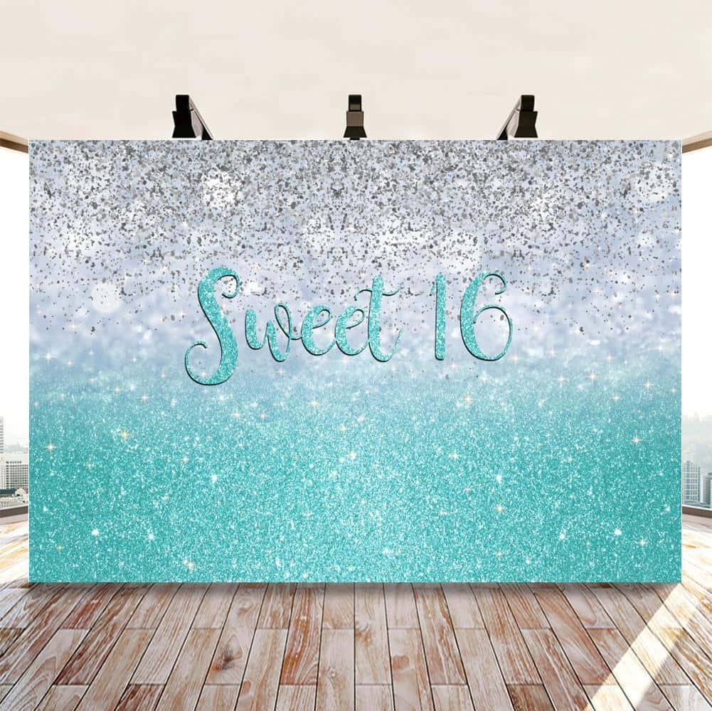 A Blue And Silver Glitter Backdrop With The Word Sweet 16