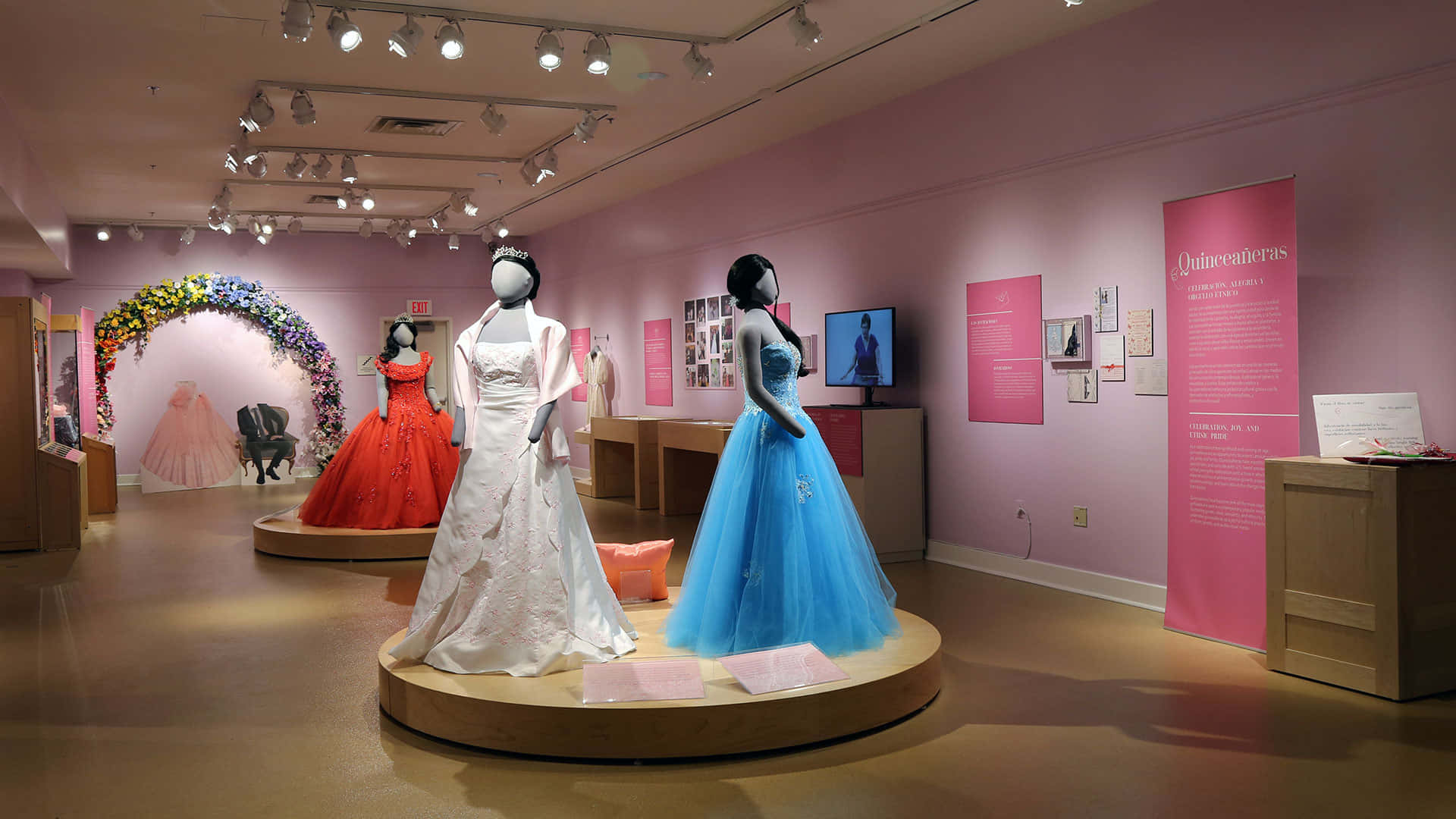 A Display Of Dresses On Display In A Museum