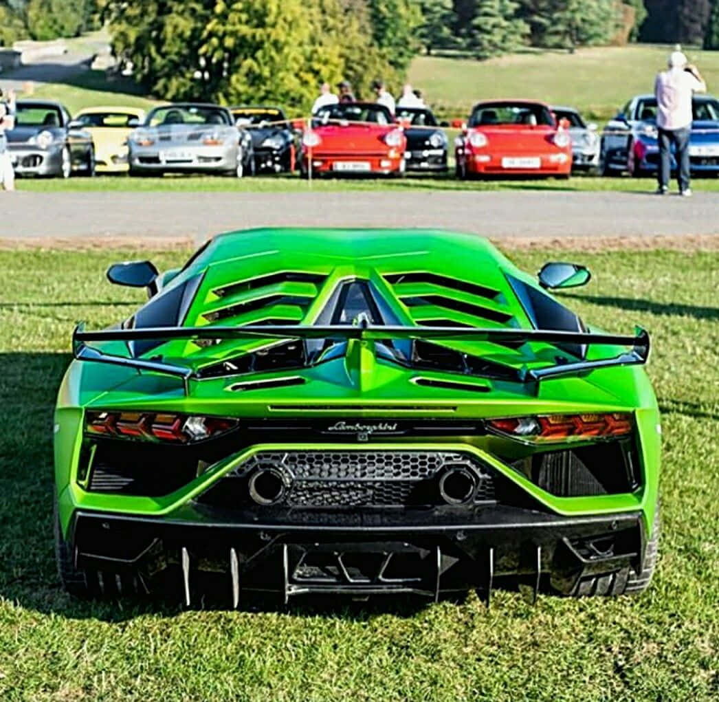A Green Sports Car Is Parked In A Grassy Area