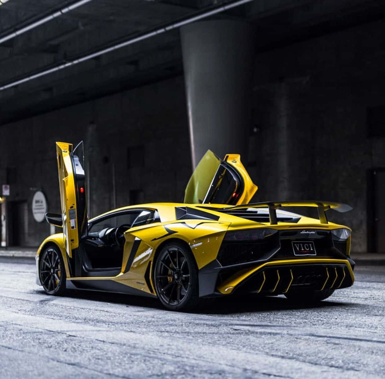 A Yellow Sports Car Is Parked In An Underground Parking Lot