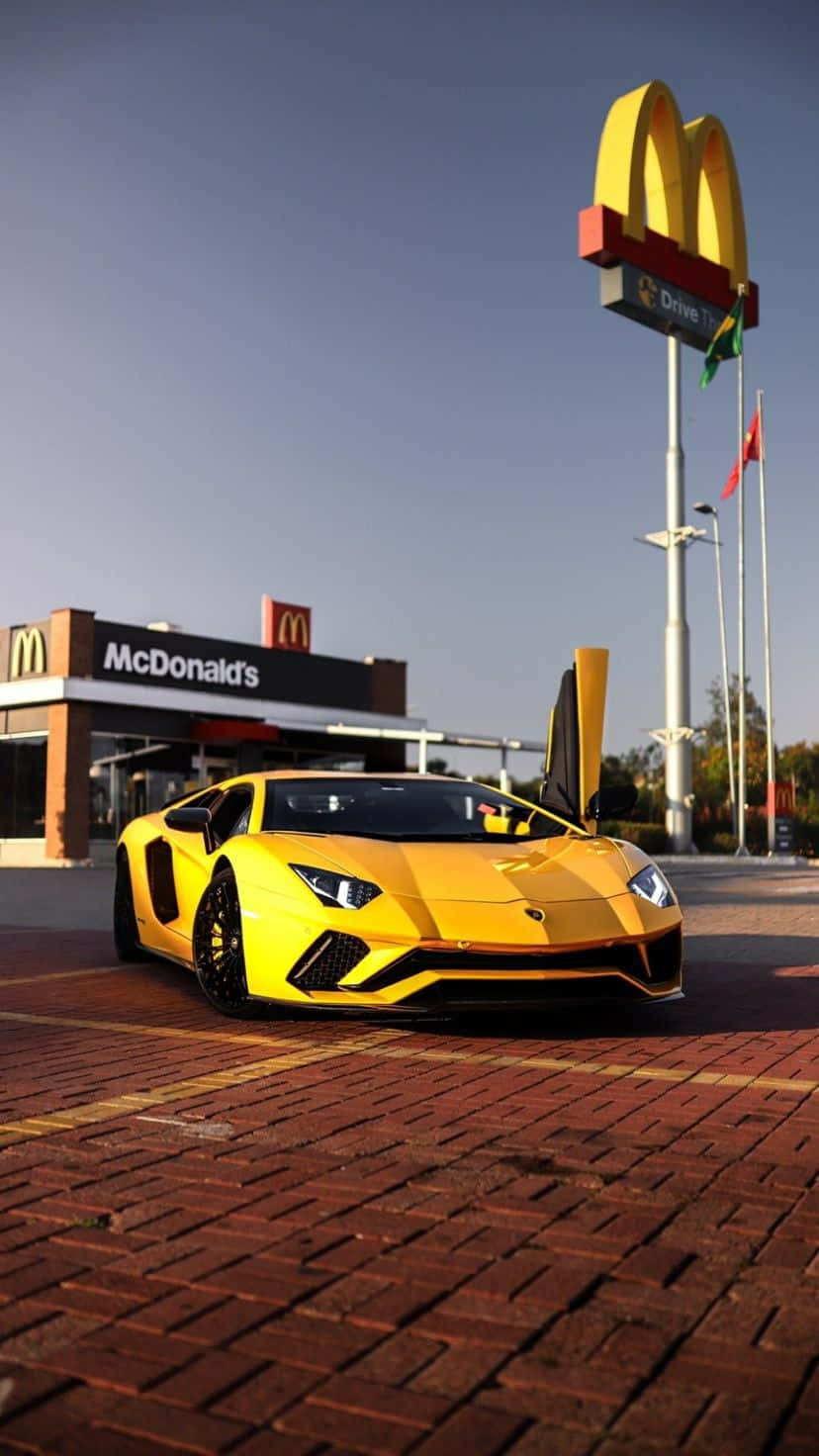 A Yellow Lamborghini Parked In Front Of A Mcdonald's