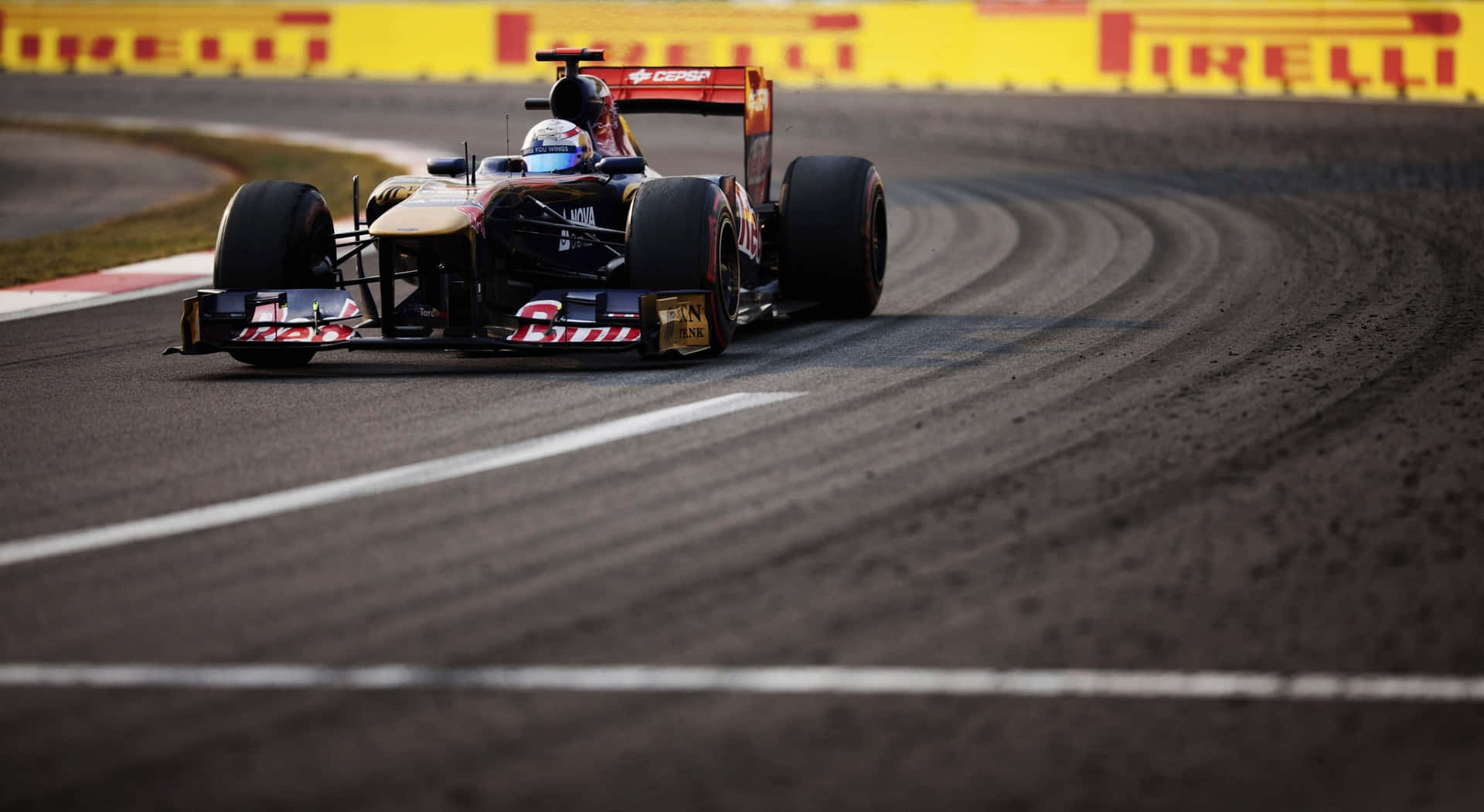 A Red Bull Racing Car Driving Down A Track