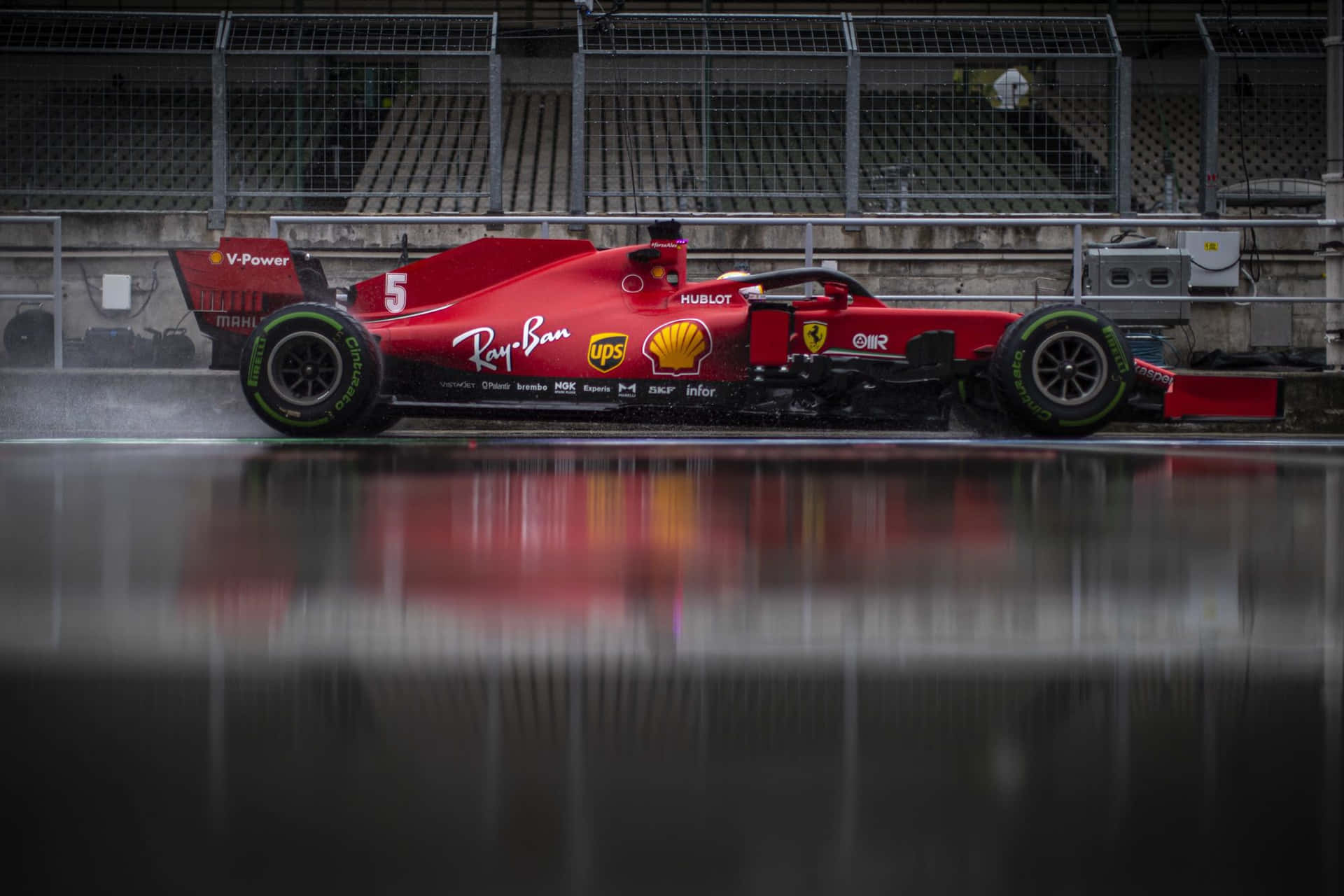 Download Ferrari F1 Car On A Wet Track | Wallpapers.com