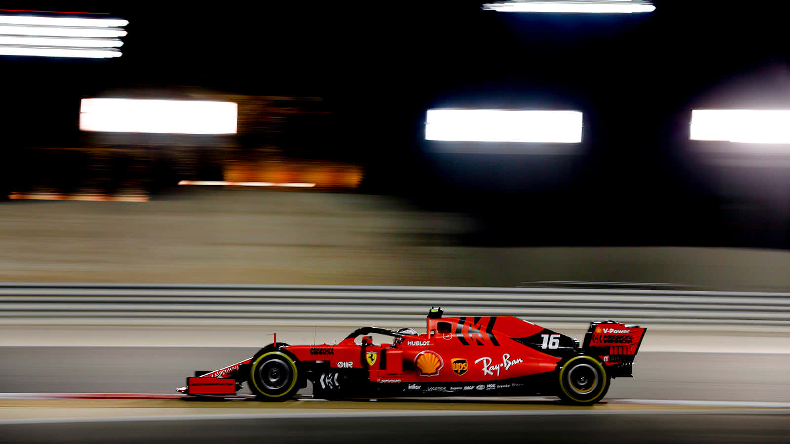 Ferrari F1 Car Driving On A Track At Night