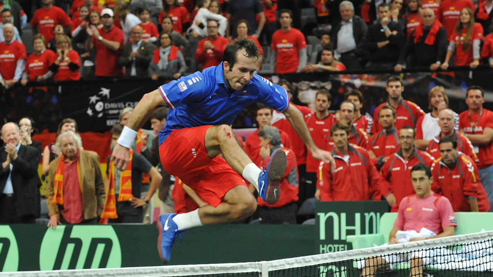 Radek Stepanek Jumping Over Tennis Net Wallpaper