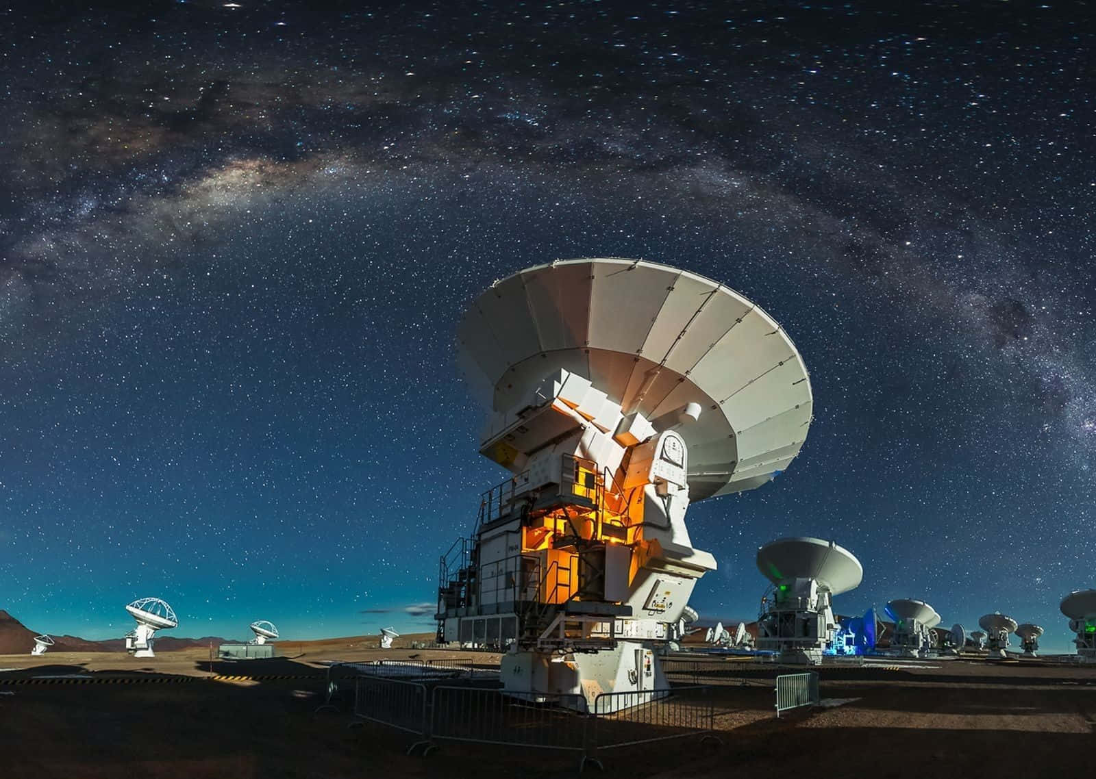 A massive radio telescope scanning the night sky for cosmic mysteries Wallpaper
