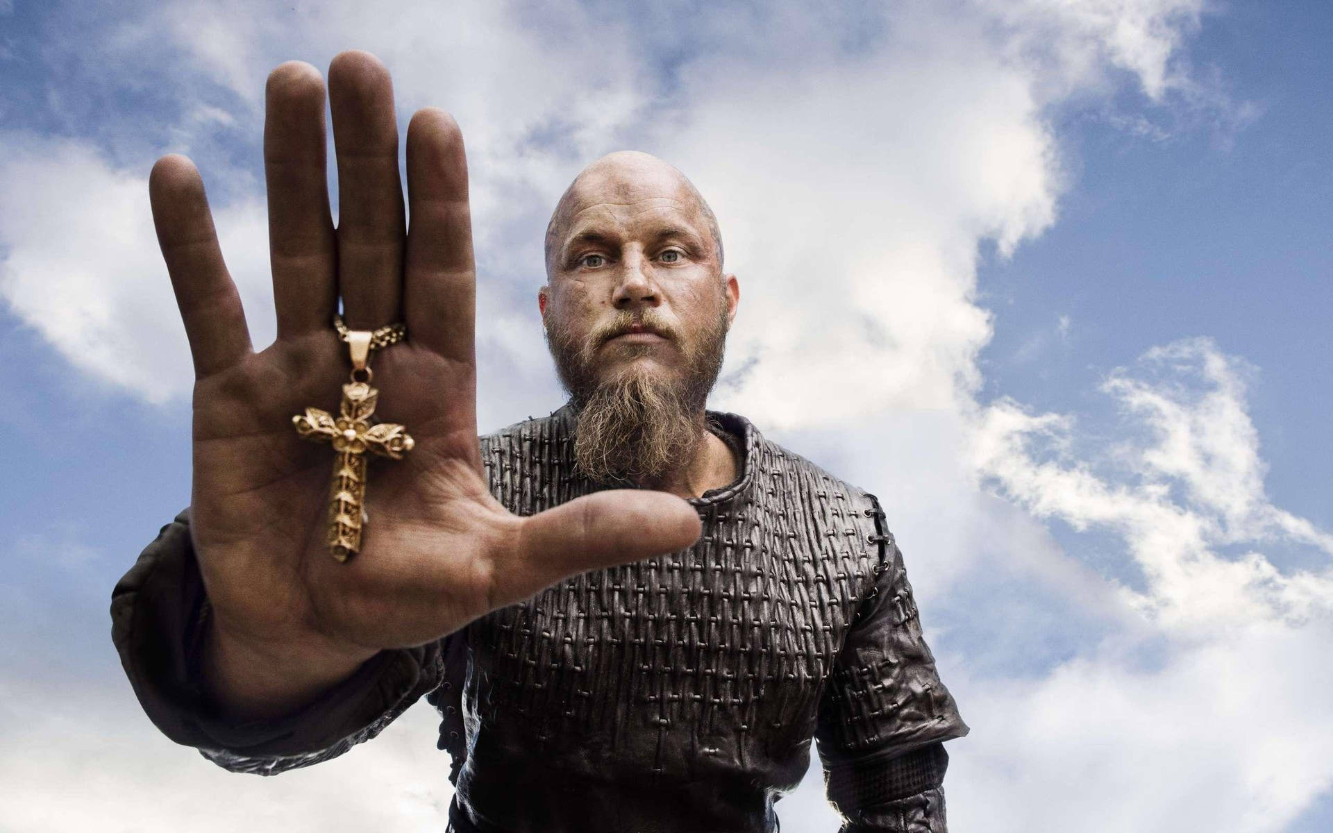 Ragnarlothbrok De Vikings Segurando Uma Cruz. Papel de Parede