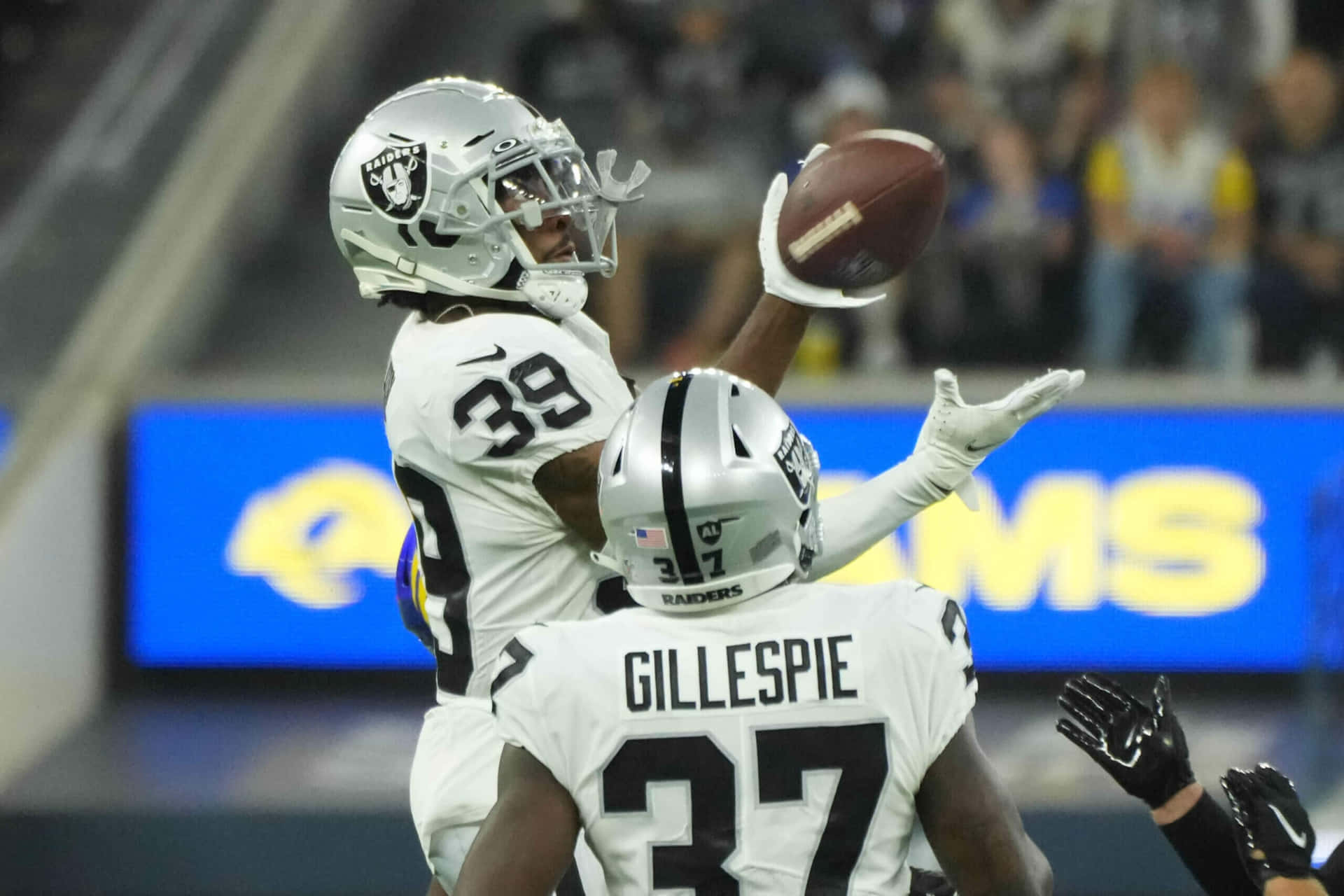 Raiders Defensive Play In Action Wallpaper