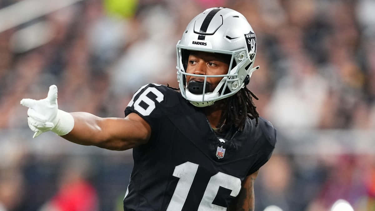 Raiders Football Player Gesturing During Game Wallpaper