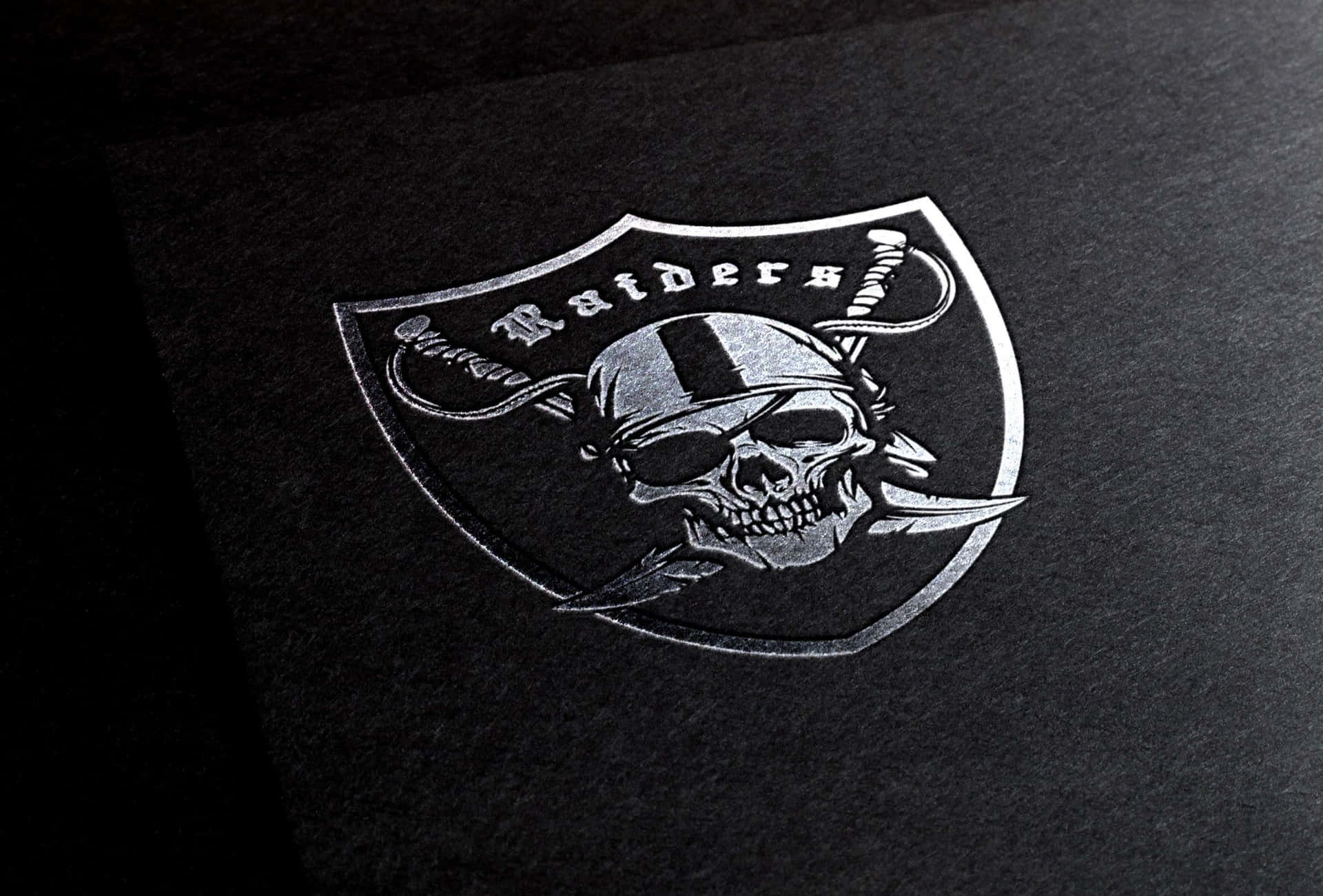 The Iconic Silver and Black Raiders Logo Wallpaper