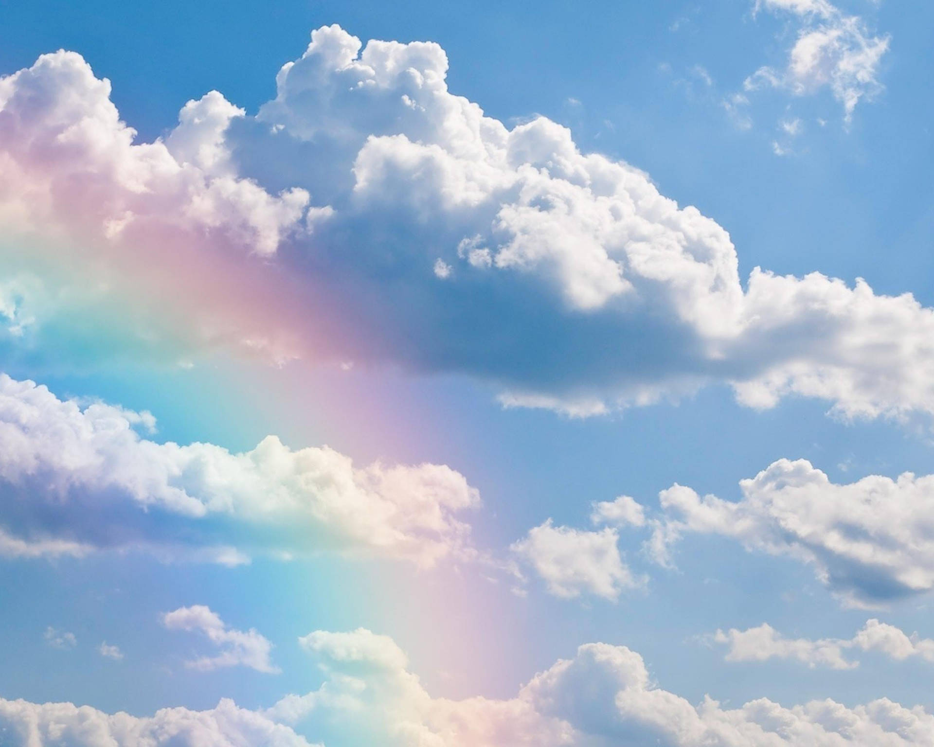 "A Harmonious Blend of Blue Aesthetics and a Rainbow in the Clouds" Wallpaper