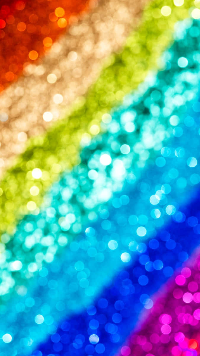 A beautiful burst of rainbow sparkles in the night sky Wallpaper