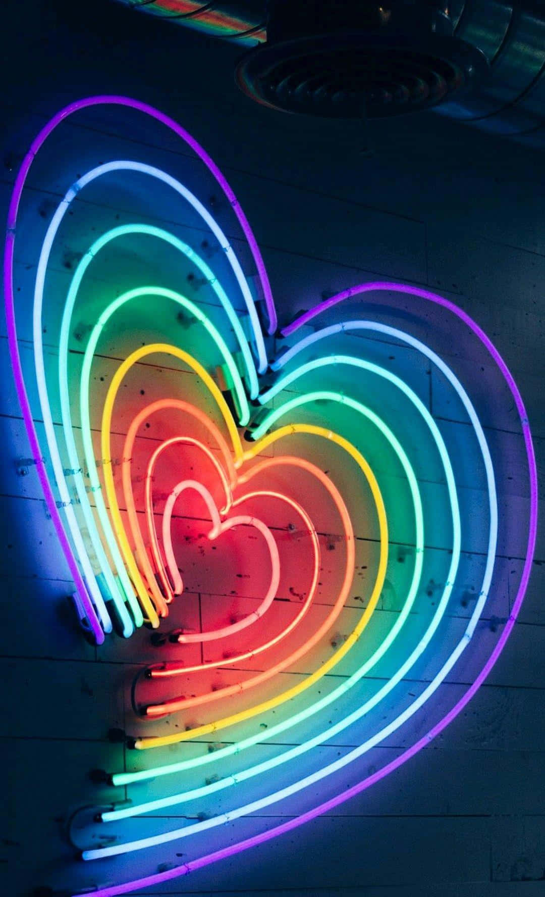 Coraçãoarco-íris Em Neon. Papel de Parede