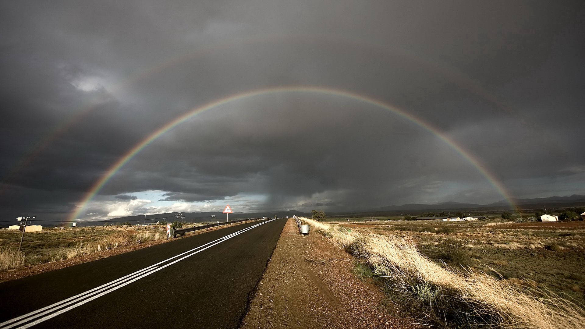 The beauty of a rainbow in the road Wallpaper