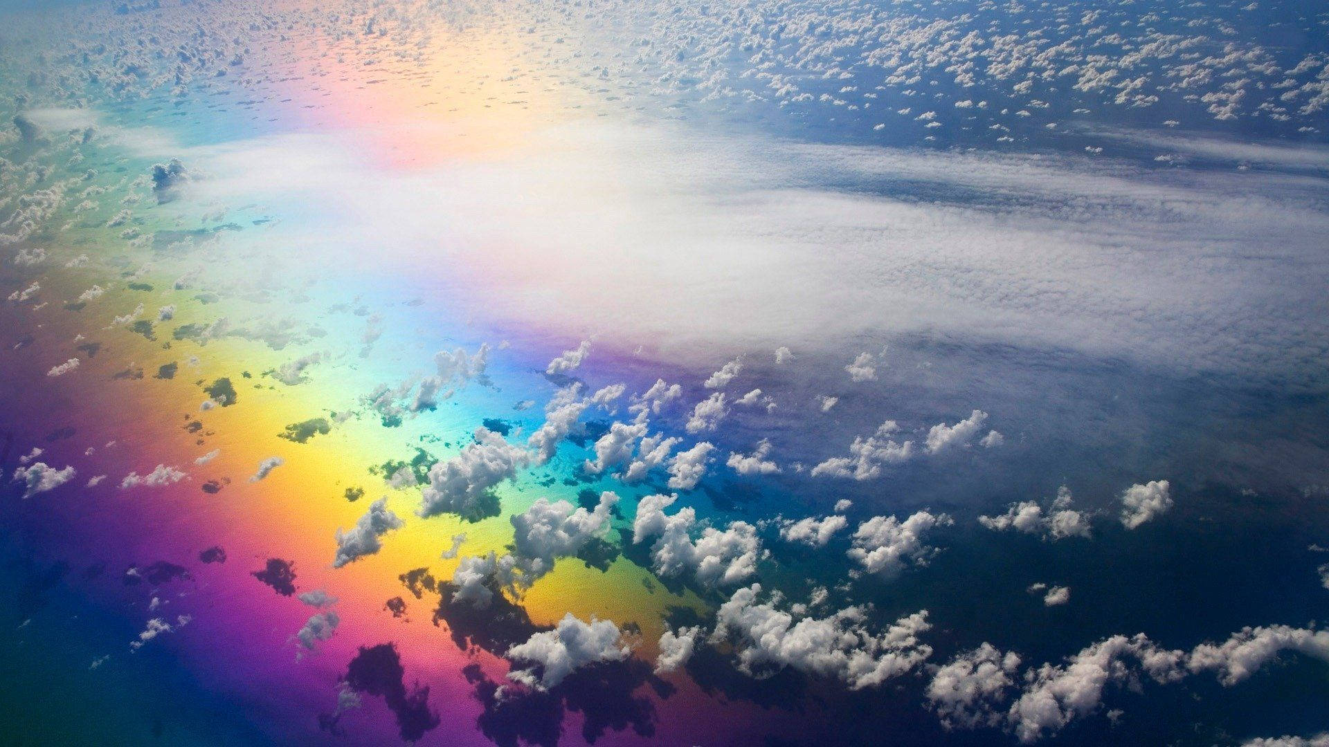 “A stunning rainbow appears in the sky, adding a magical touch to the day.” Wallpaper