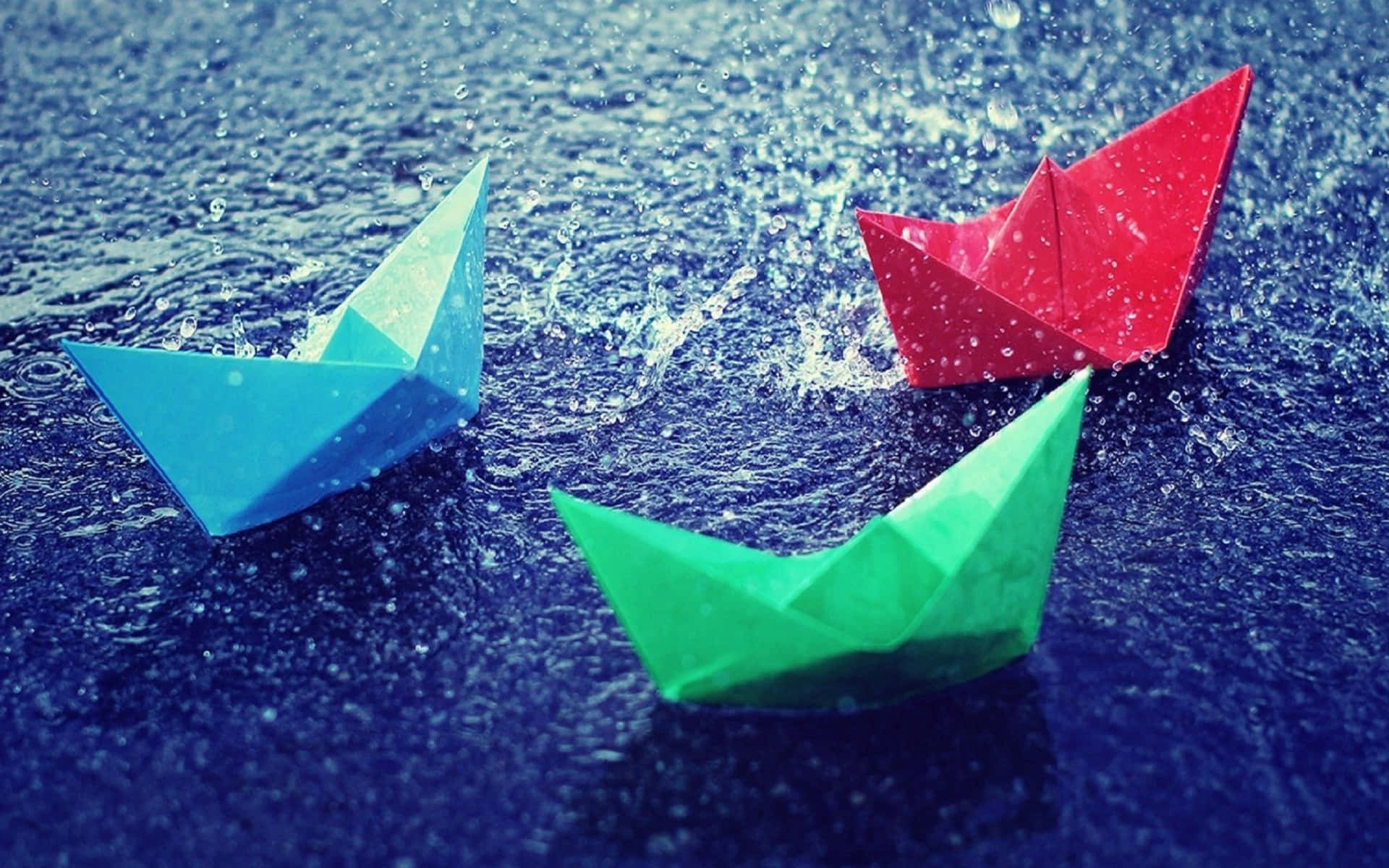Three Paper Boats Floating In The Water