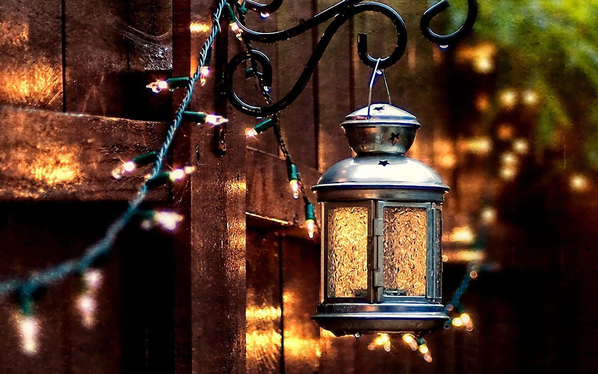 A Lantern Hanging On A Fence With Lights