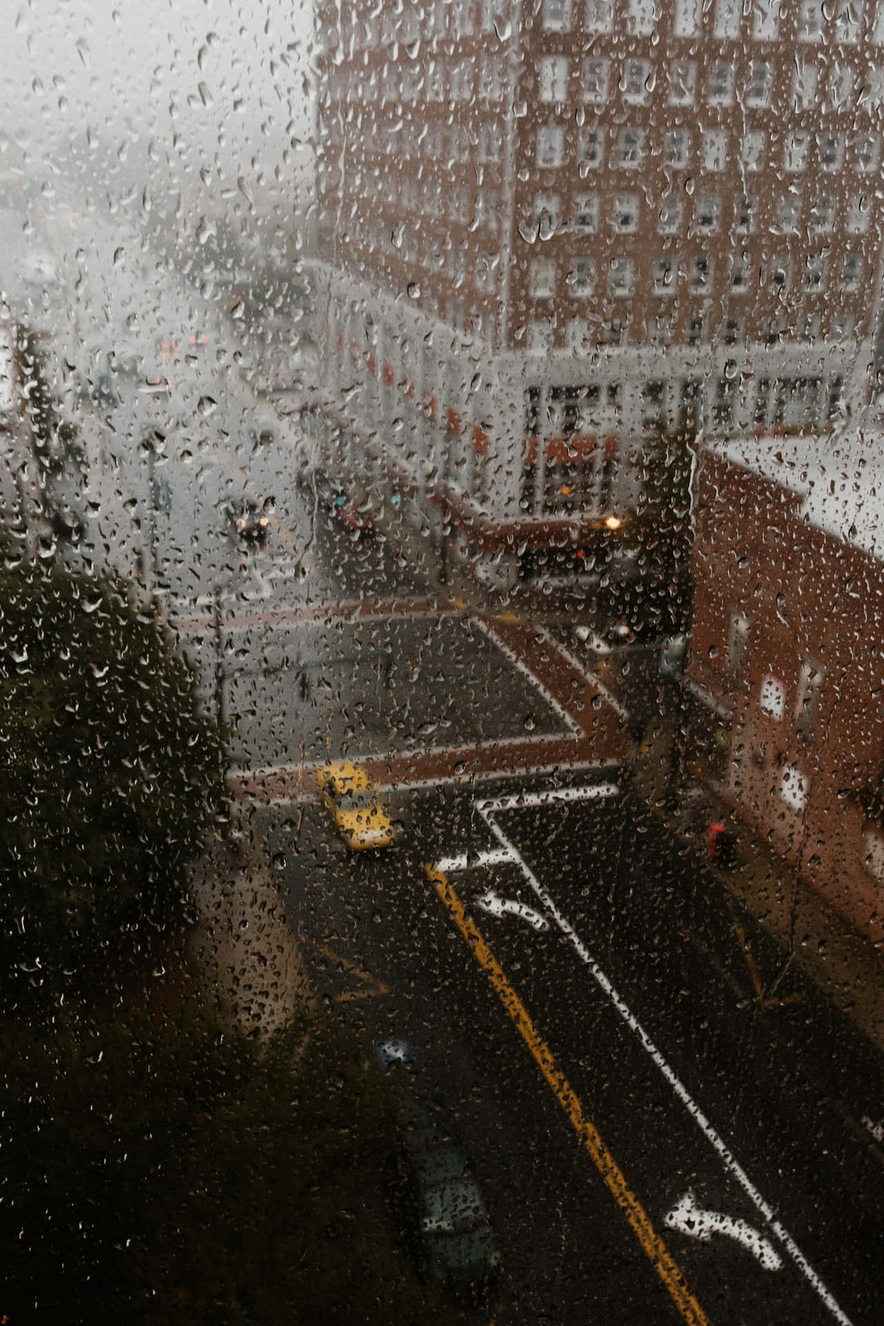 Rainy Cityscape Through Window.jpg Wallpaper