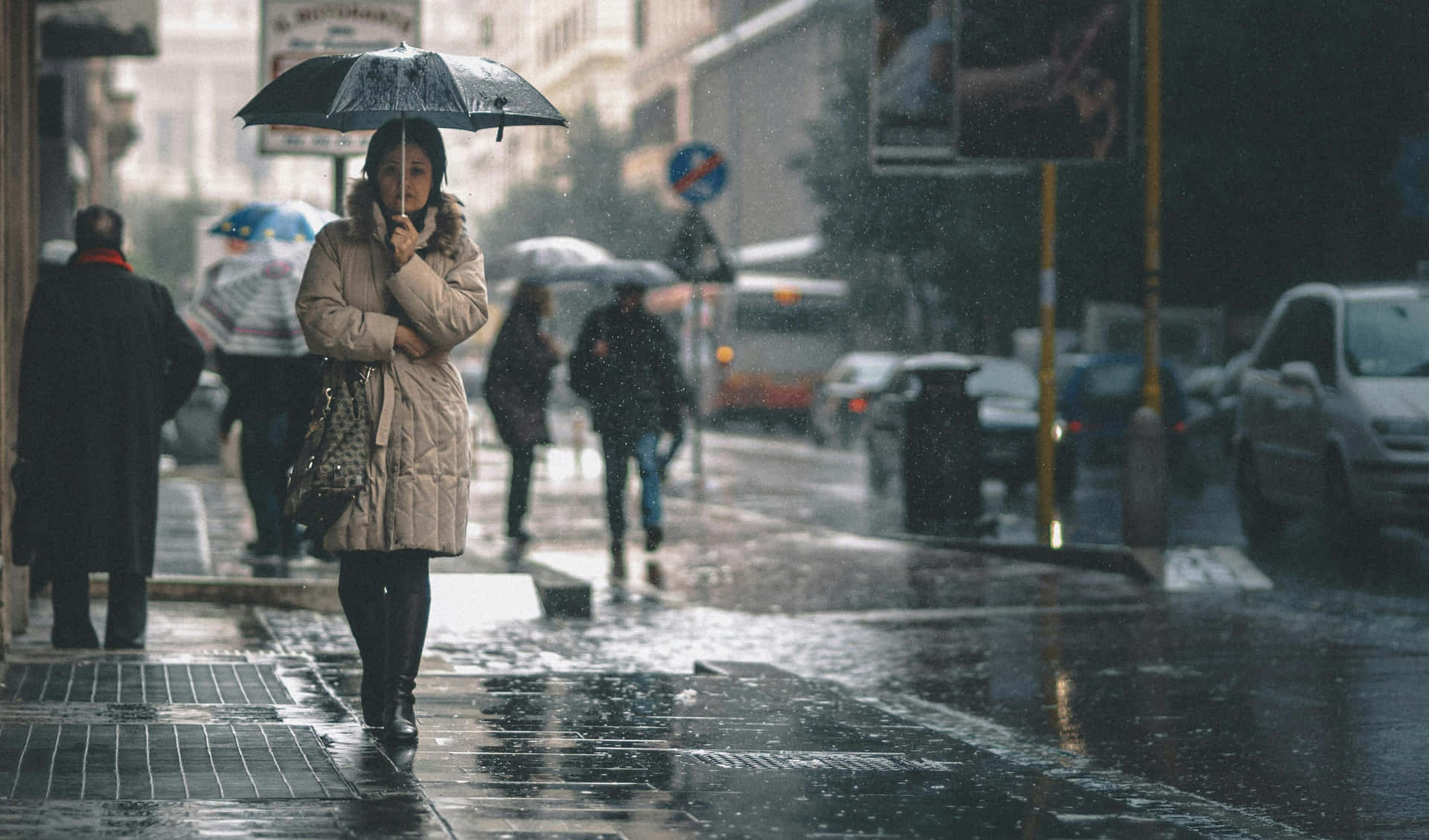 Rainy_ Cityscape_with_ Umbrella Wallpaper