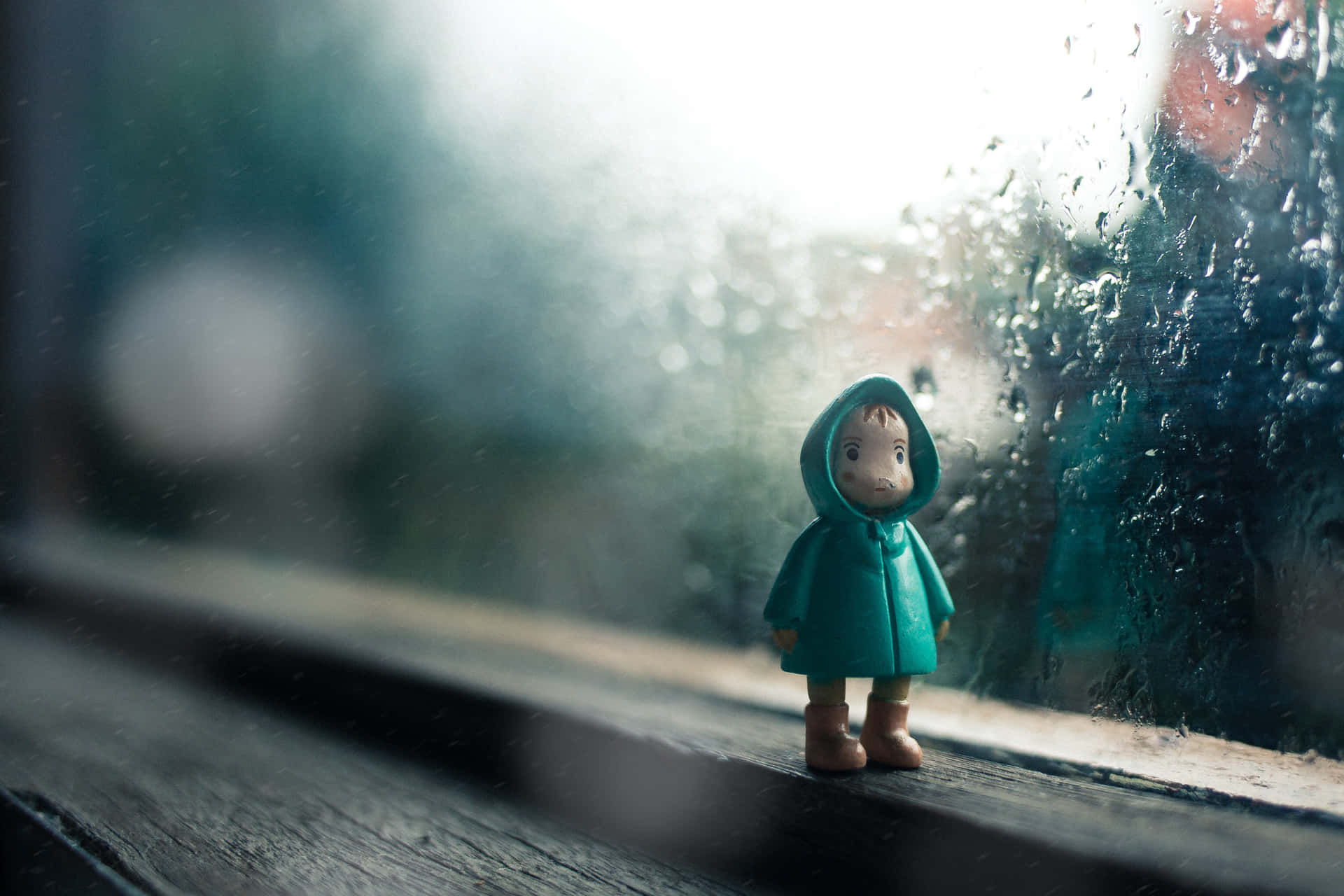 Chibi Toy By The Window During Rainy Day Picture