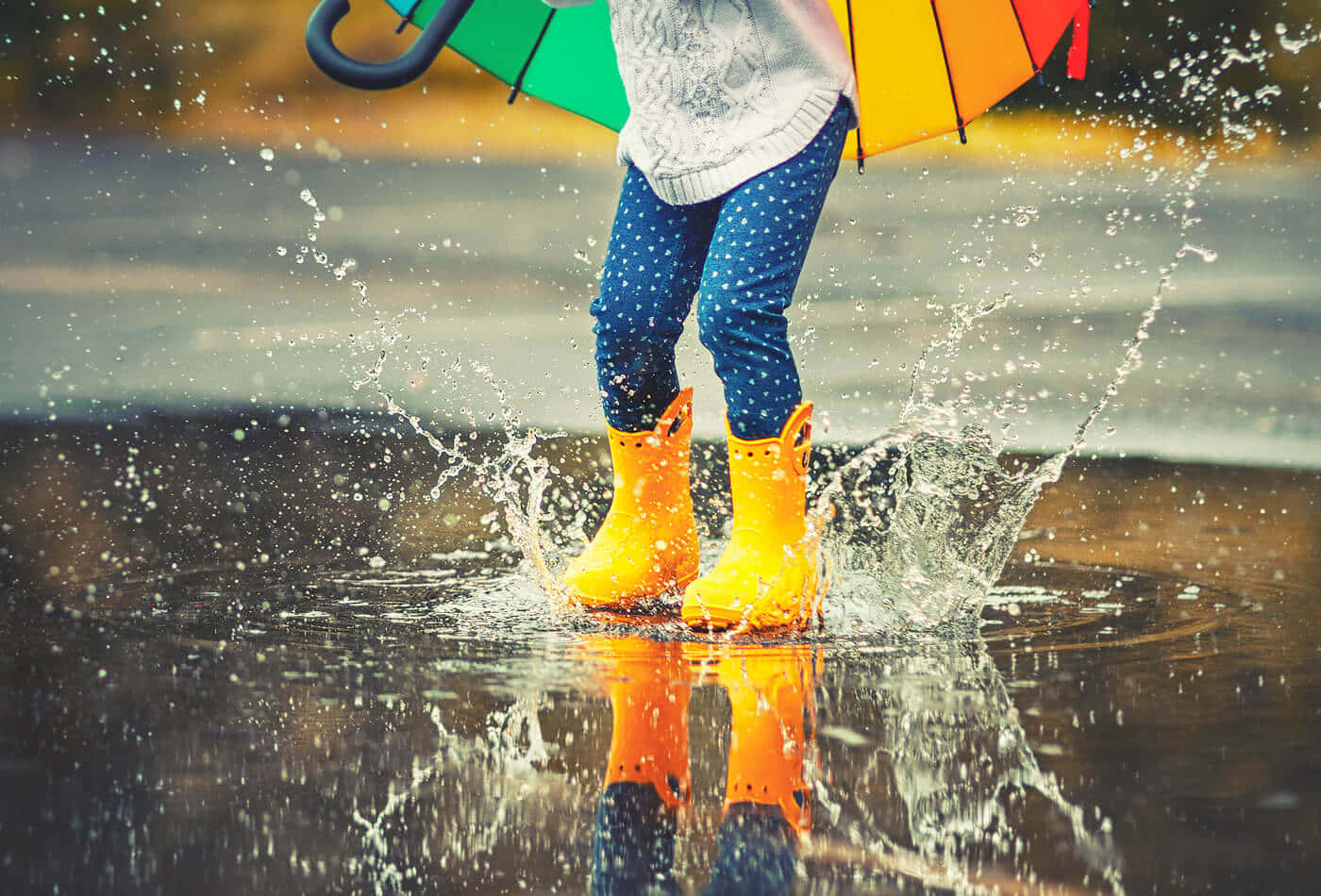 Jumping On Puddle With Colorful Umbrella During Rainy Day Picture