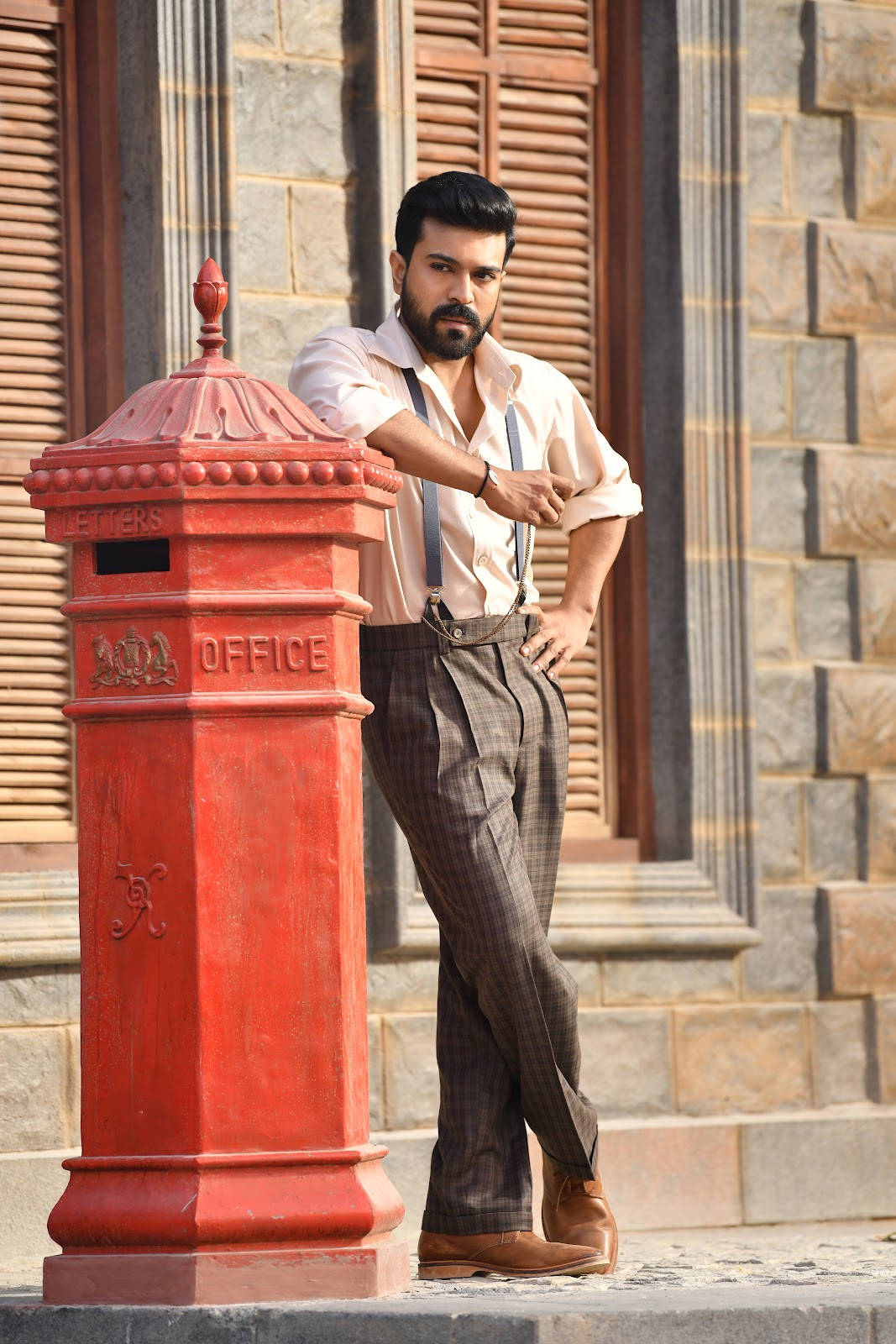 Ram Charan Leaning Against A Mailbox Wallpaper
