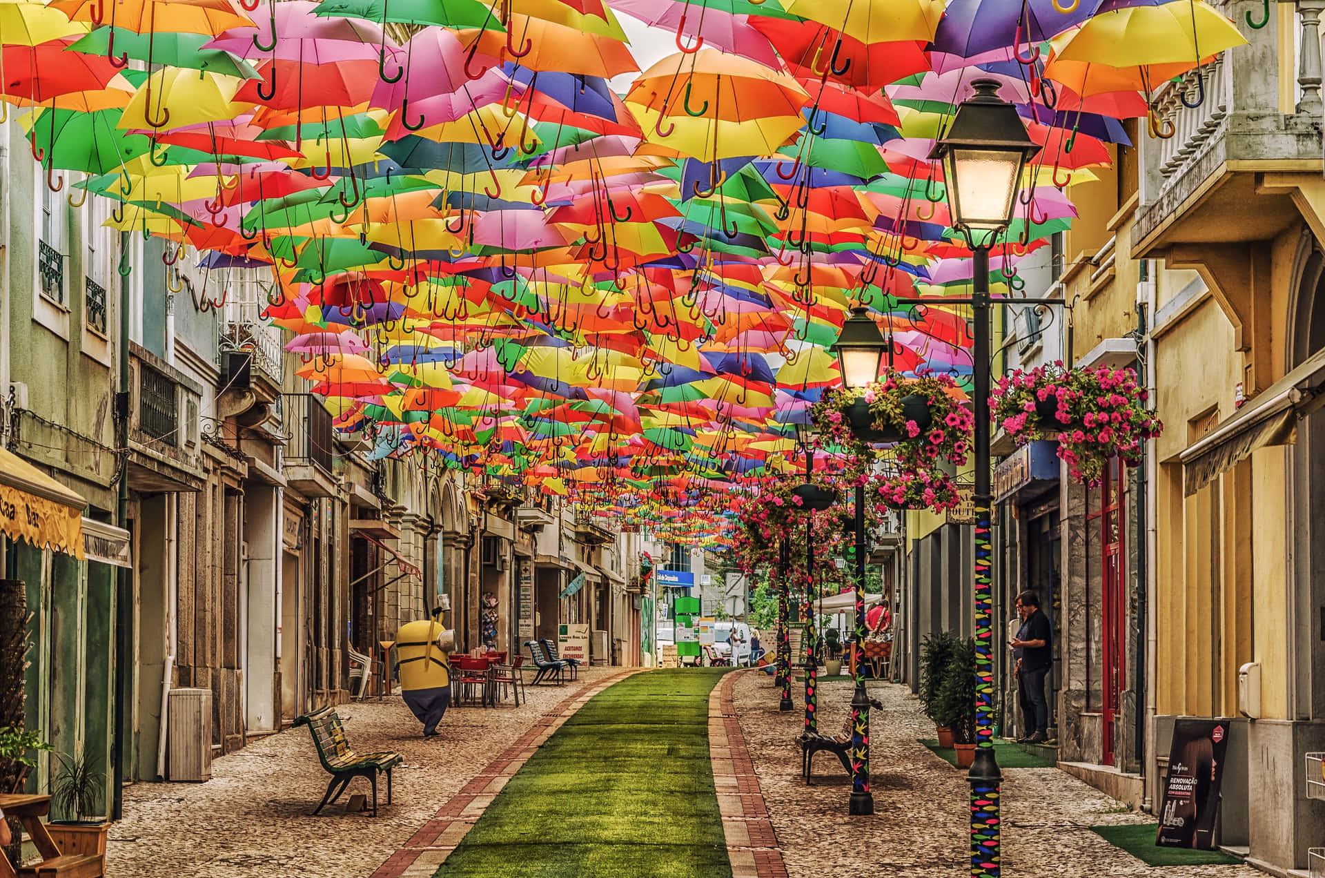 Random Person In Street With Colorful Umbrellas Wallpaper