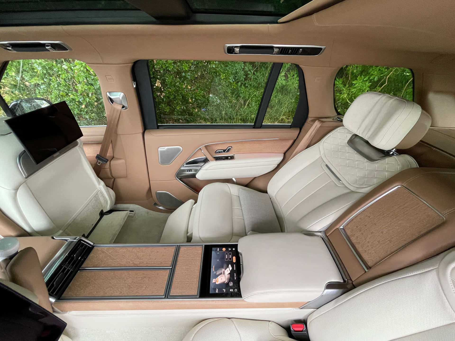 The Interior Of A Suv With Leather Seats And A Leather Steering Wheel