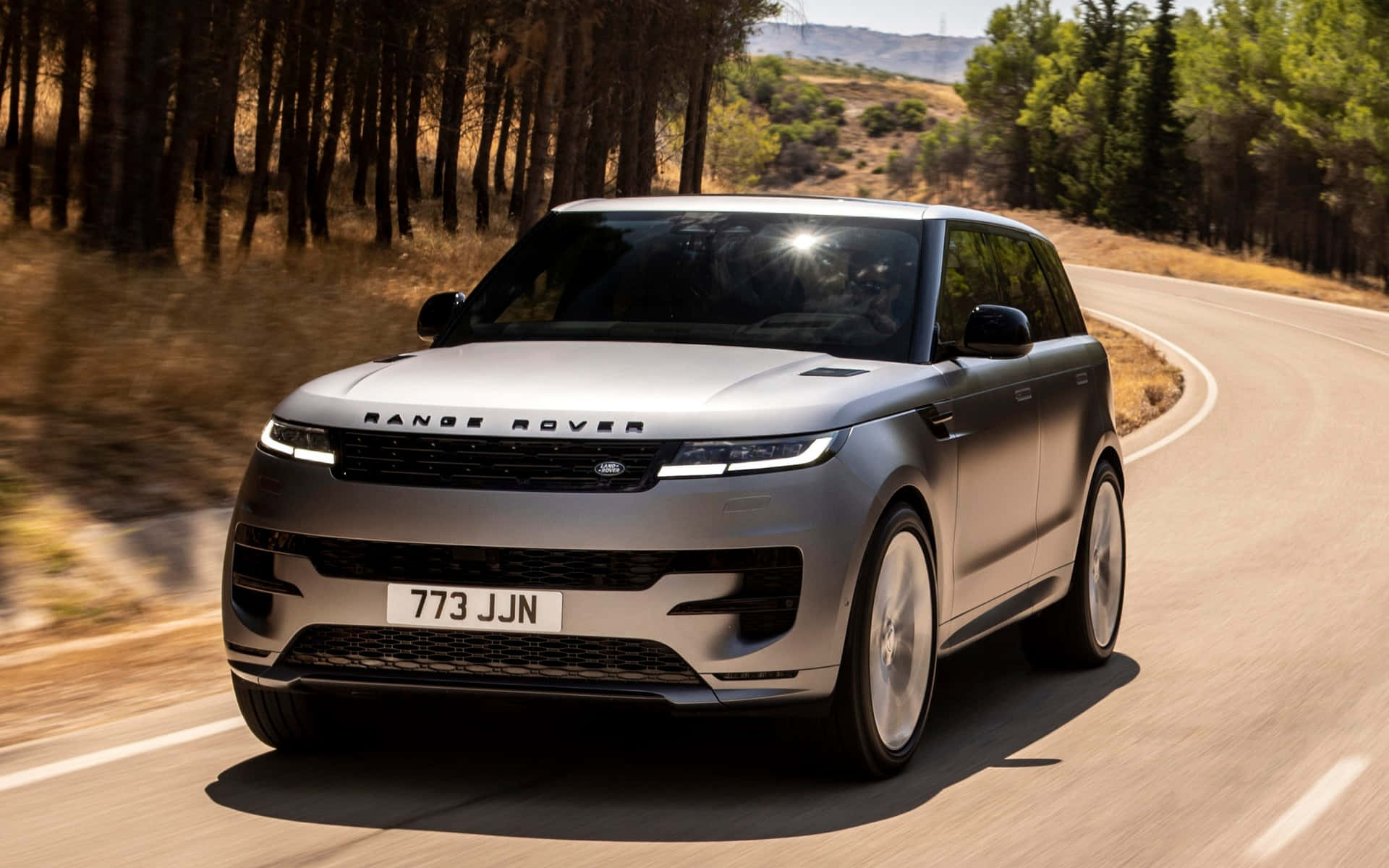 The New Land Rover Evoque Is Driving Down A Country Road