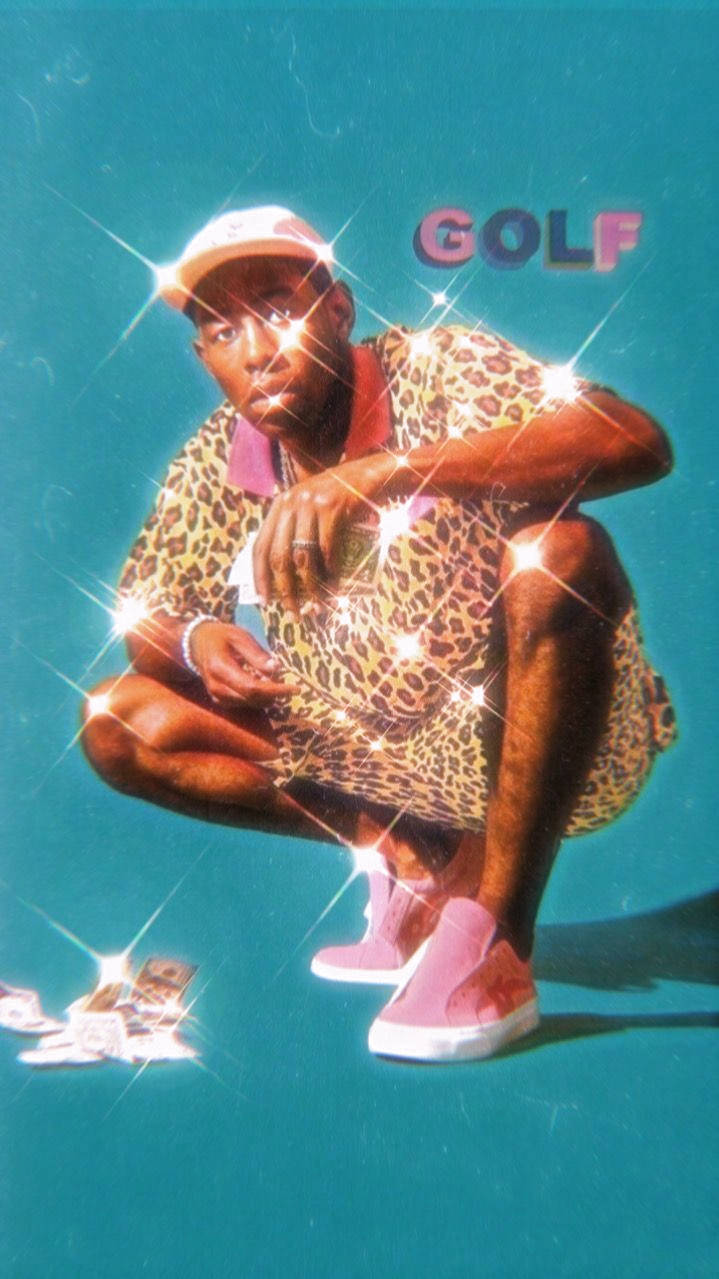 A Man In Leopard Pants Is Kneeling Down With A Golf Ball Wallpaper