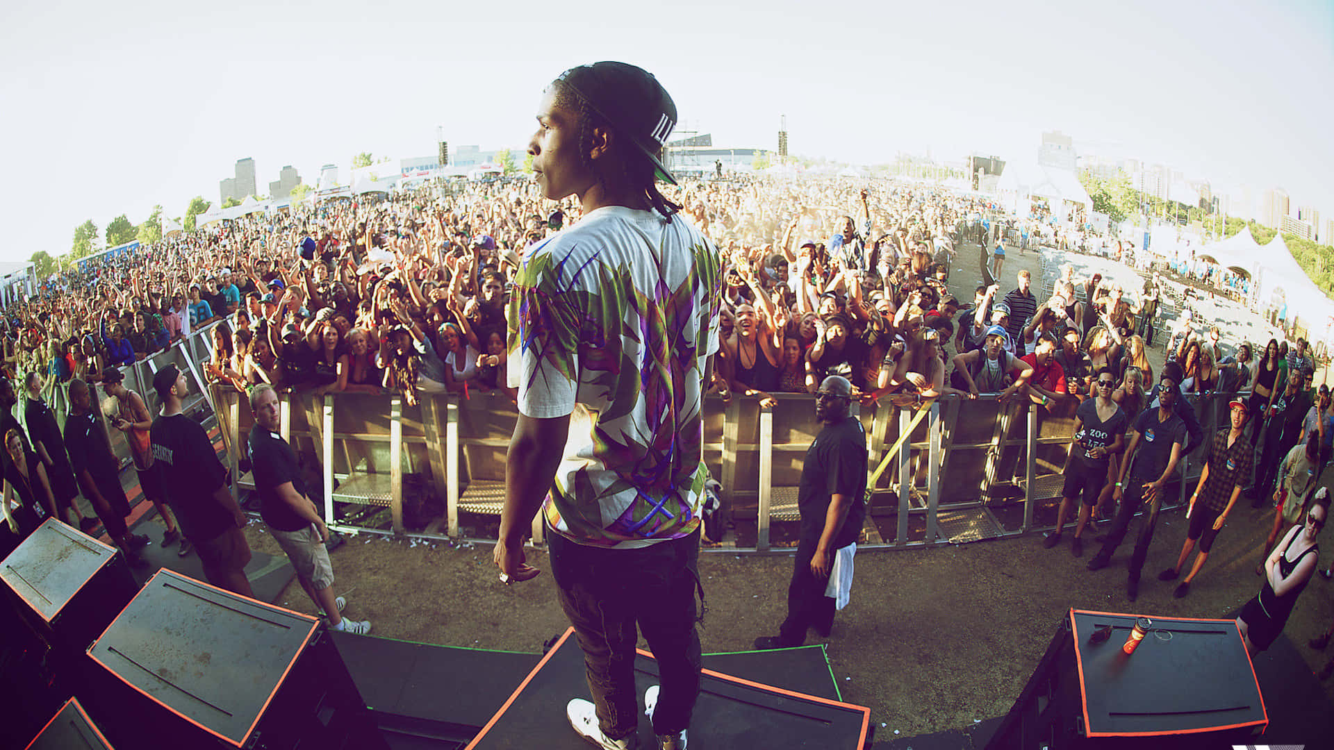 A Man Standing On Top Of A Stage In Front Of A Crowd Wallpaper