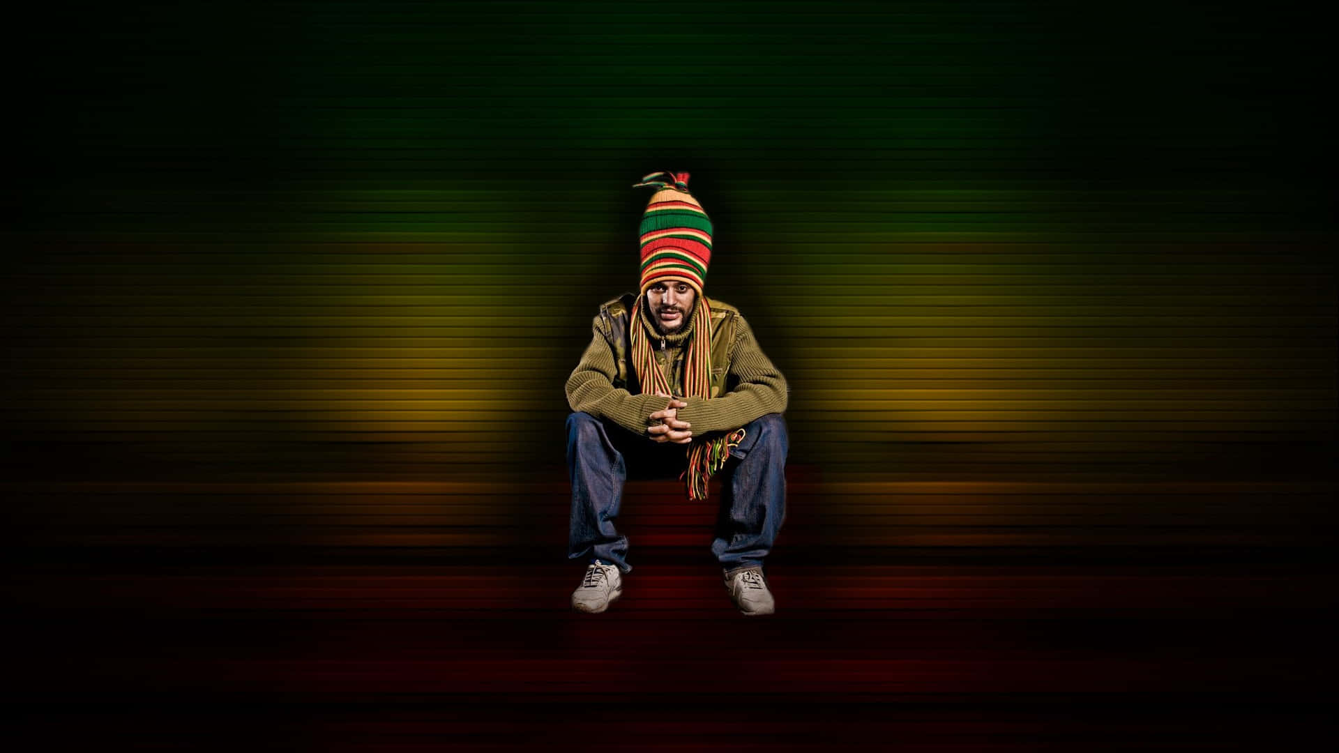 A Man In A Hat Sitting On The Ground Wallpaper