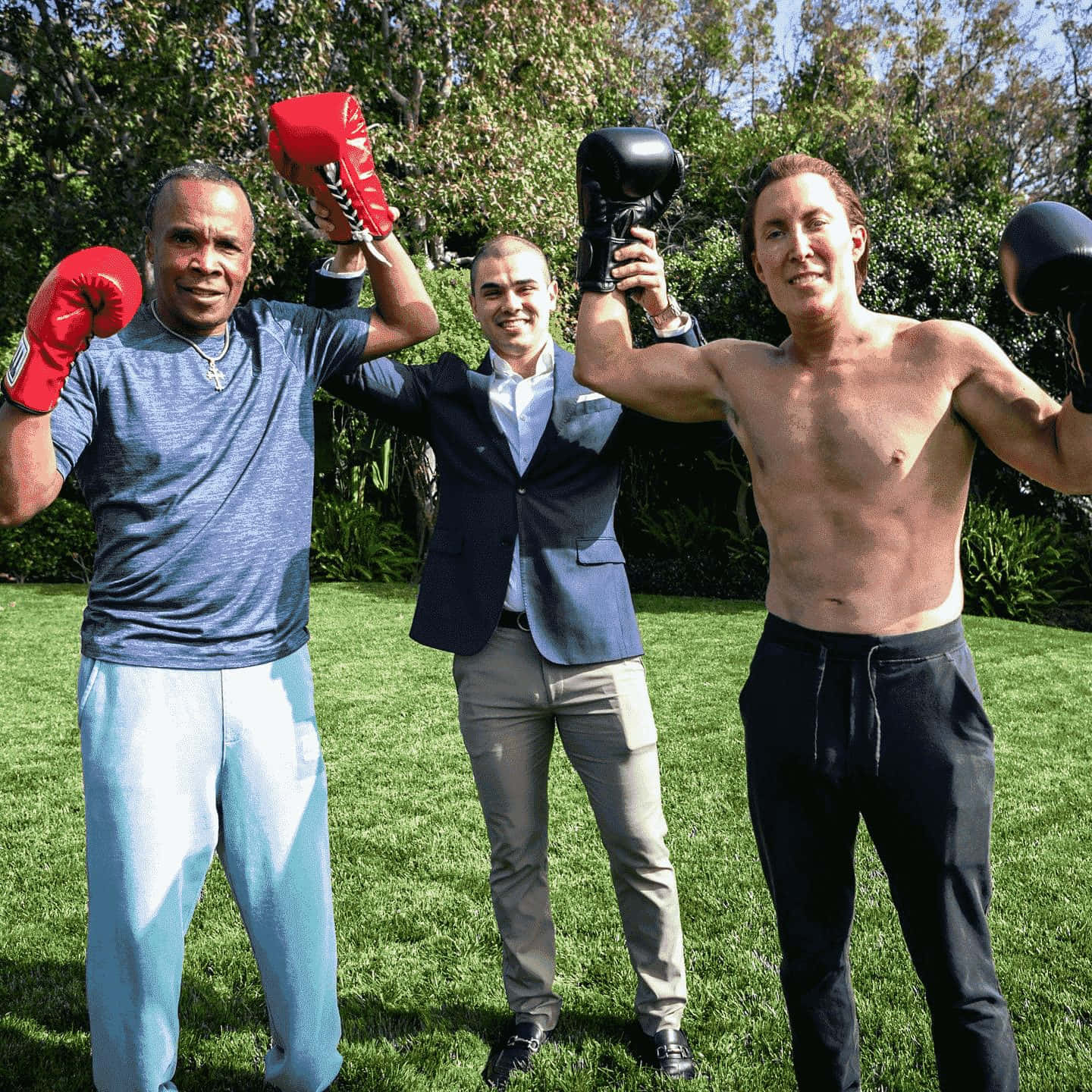 Ray Leonard Flexing With Other Boxer Outdoors Wallpaper
