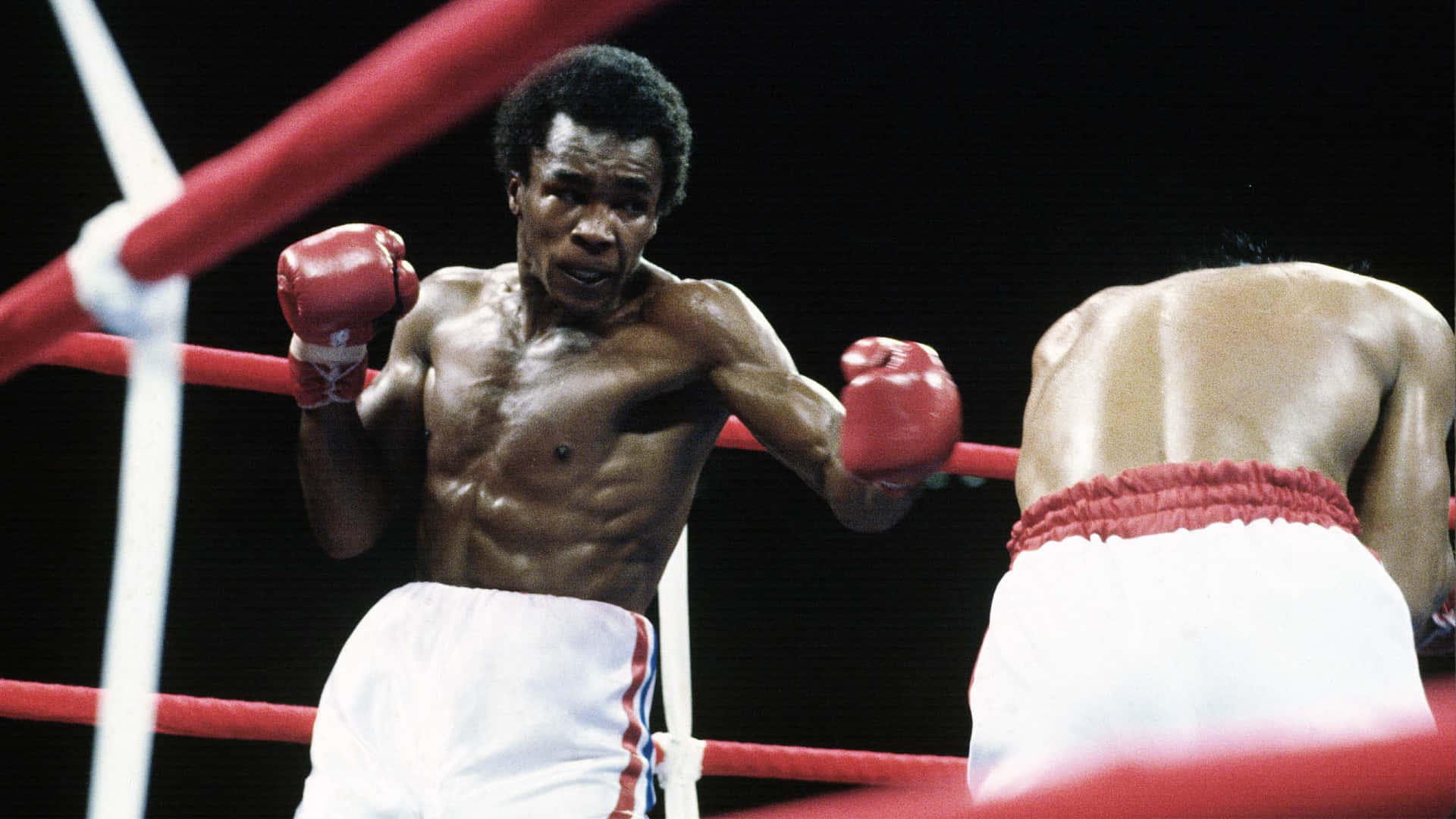 Ray Leonard Stands Over Foe With Black Backdrop Wallpaper
