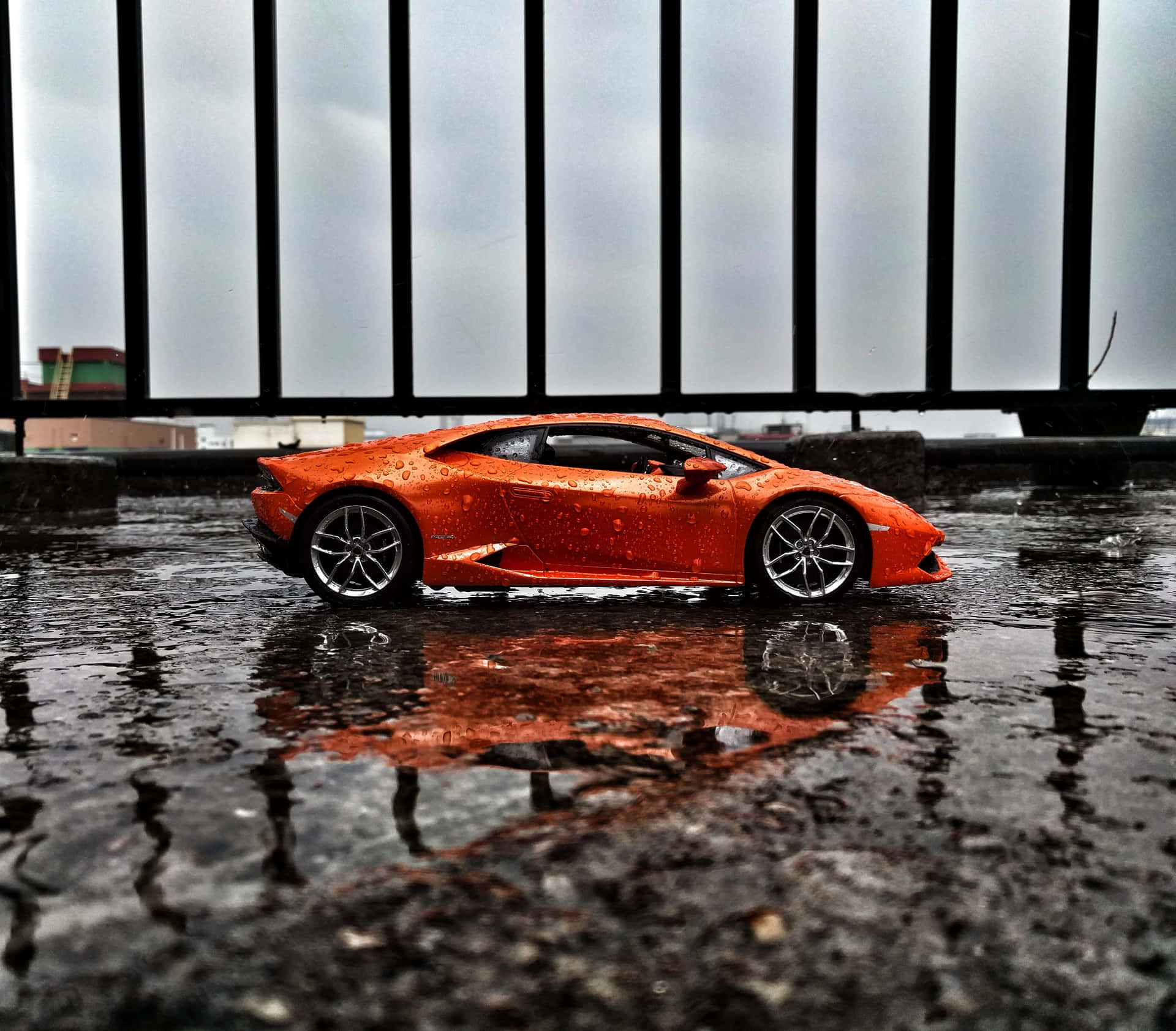 A Toy Car Is Sitting In A Puddle Of Water Wallpaper