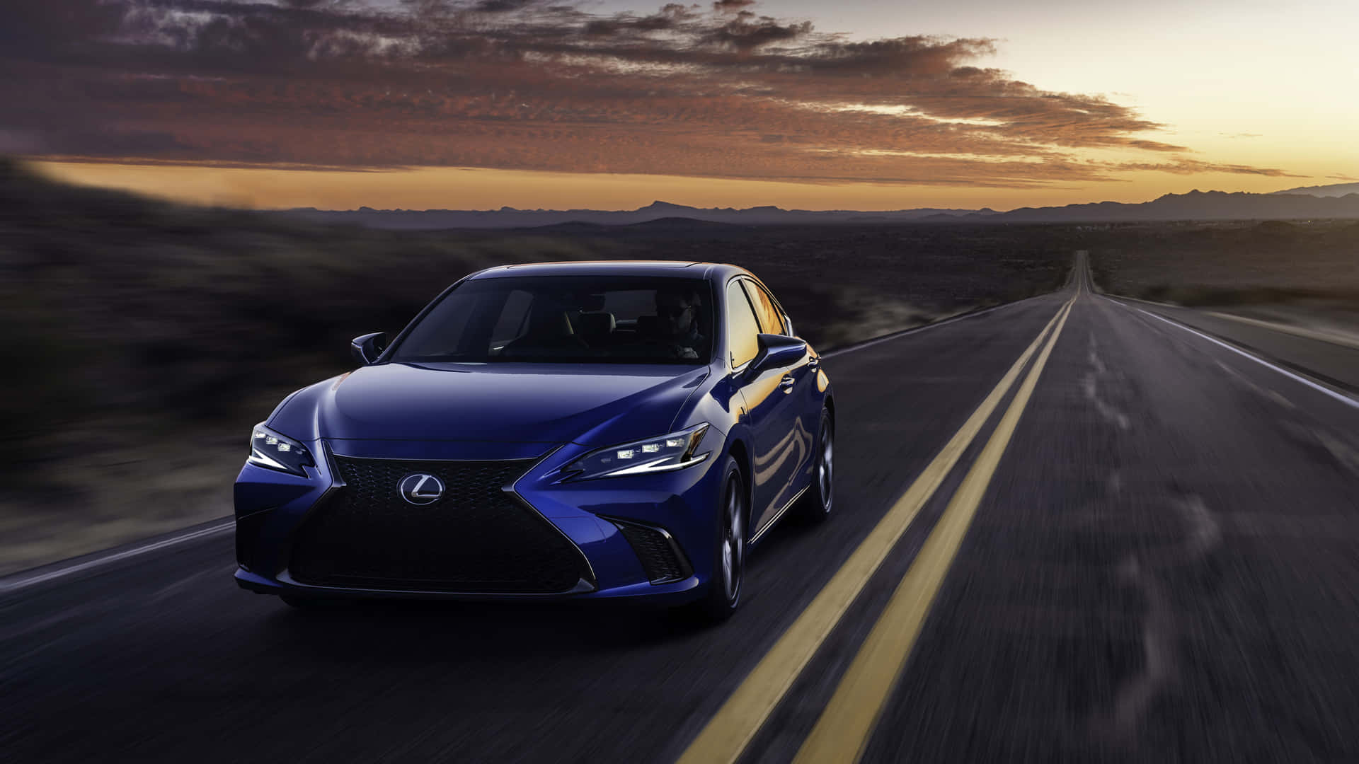 The 2019 Lexus Cs Driving Down A Road At Sunset Wallpaper